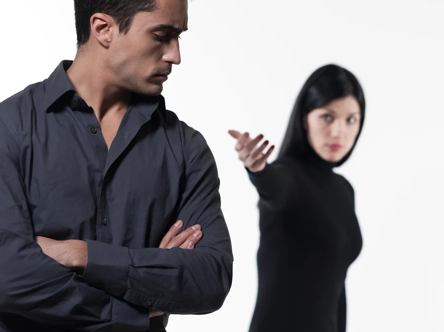 young couple on white background having a dispute