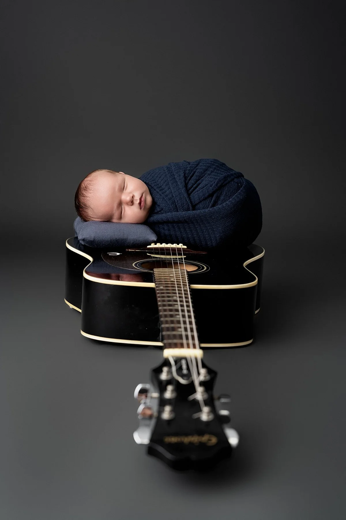 edwardsville-newborn-photographer-baby-on-guitar.jpg
