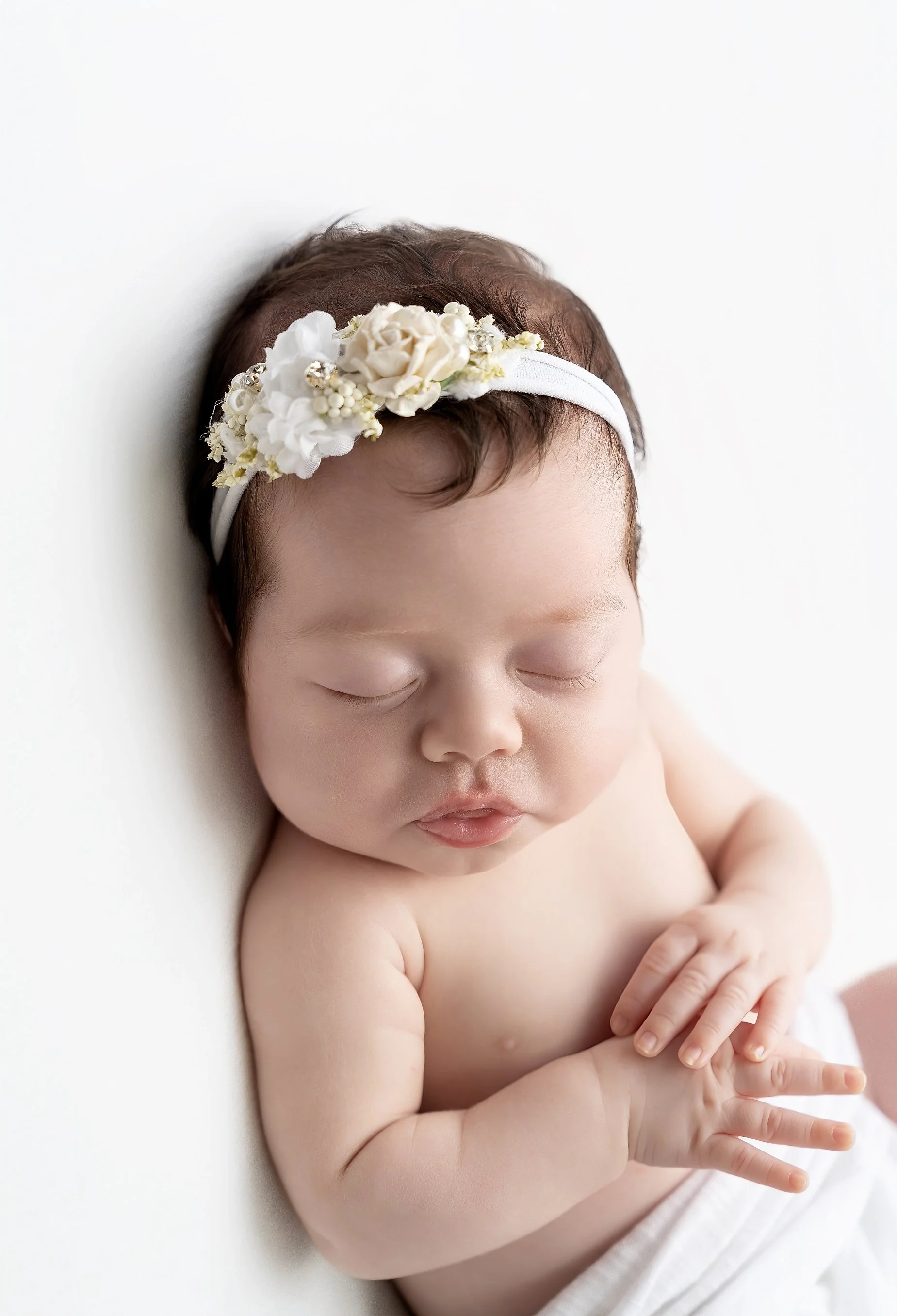 Close-up newborn baby girl portrait on white background in Glen Carbon IL studio