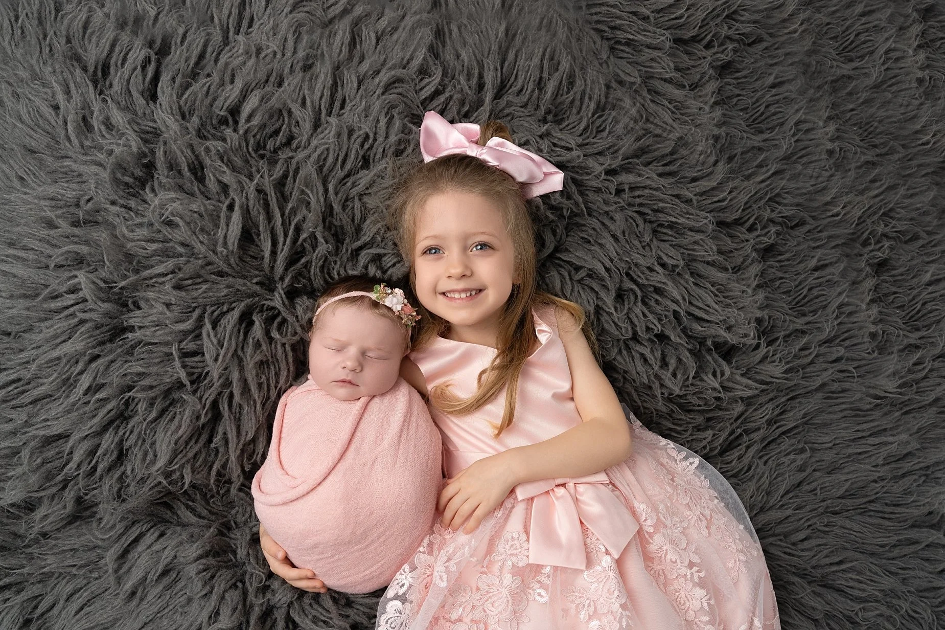 Sibling newborn portrait featuring baby girl and older sister photographed by Glen Carbon newborn photographer.