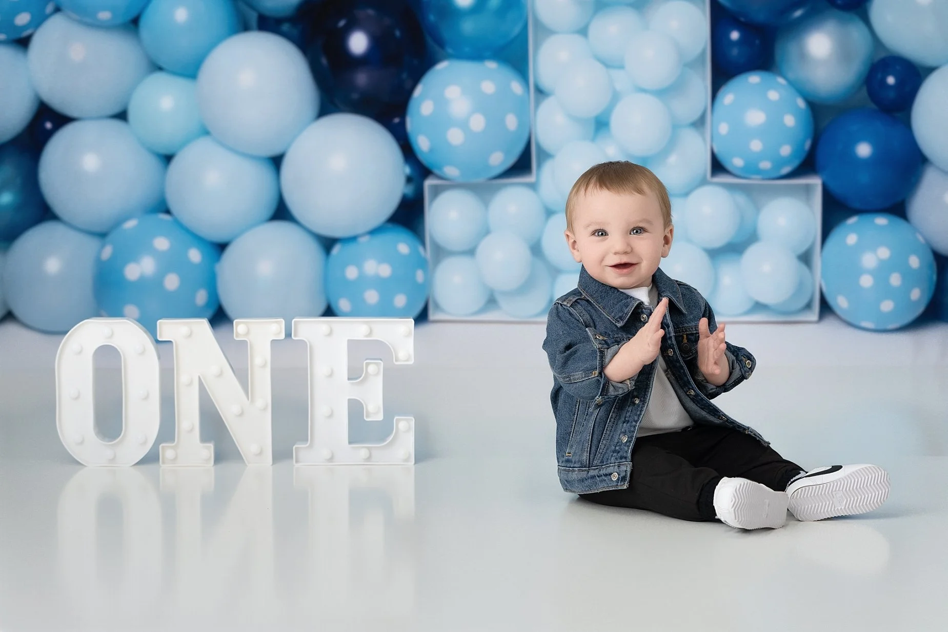 One year old baby boy clapping during milestone photography session Glen Carbon IL.