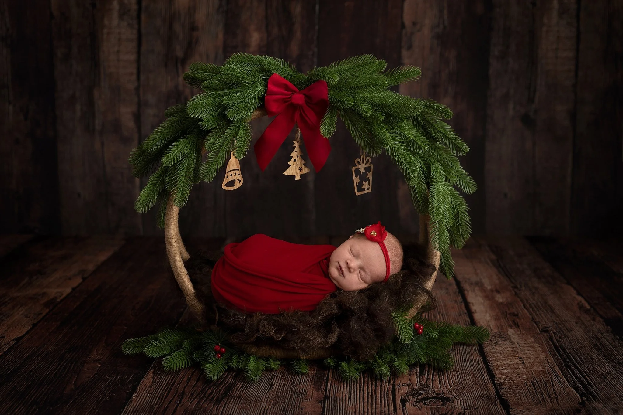 Studio newborn girl photography with pink wrap and floral details in Glen Carbon, Illinois