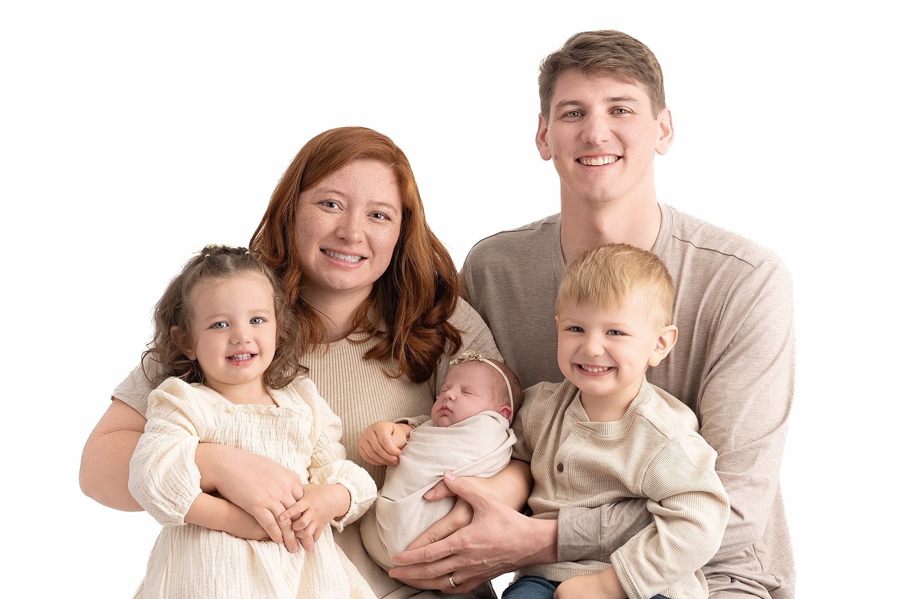 Parents and siblings holding newborn baby Emilia during a family newborn photography session in Glen Carbon Illinois.