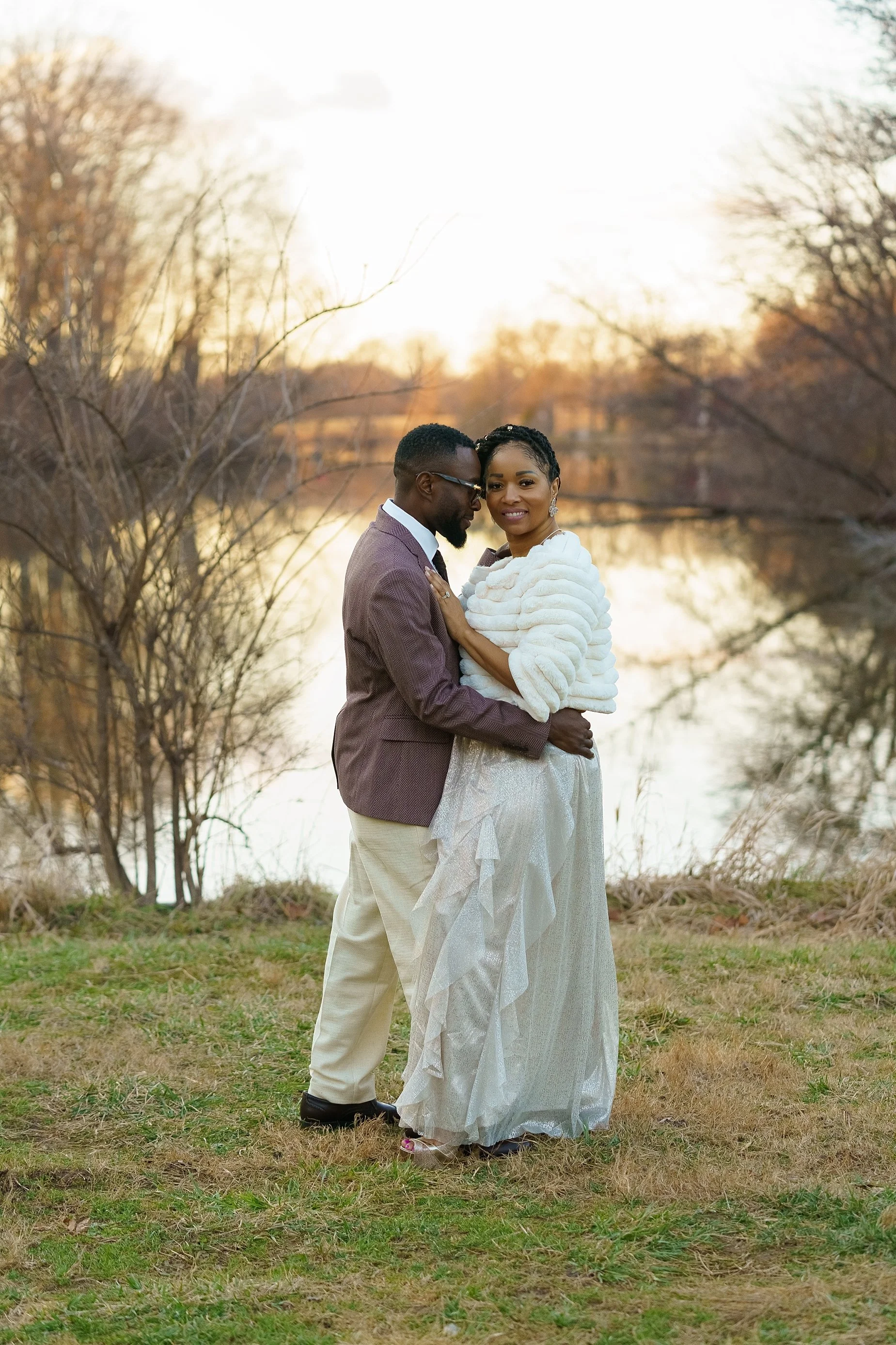 Romantic sunset wedding portrait of couple embracing near water in Glen Carbon IL