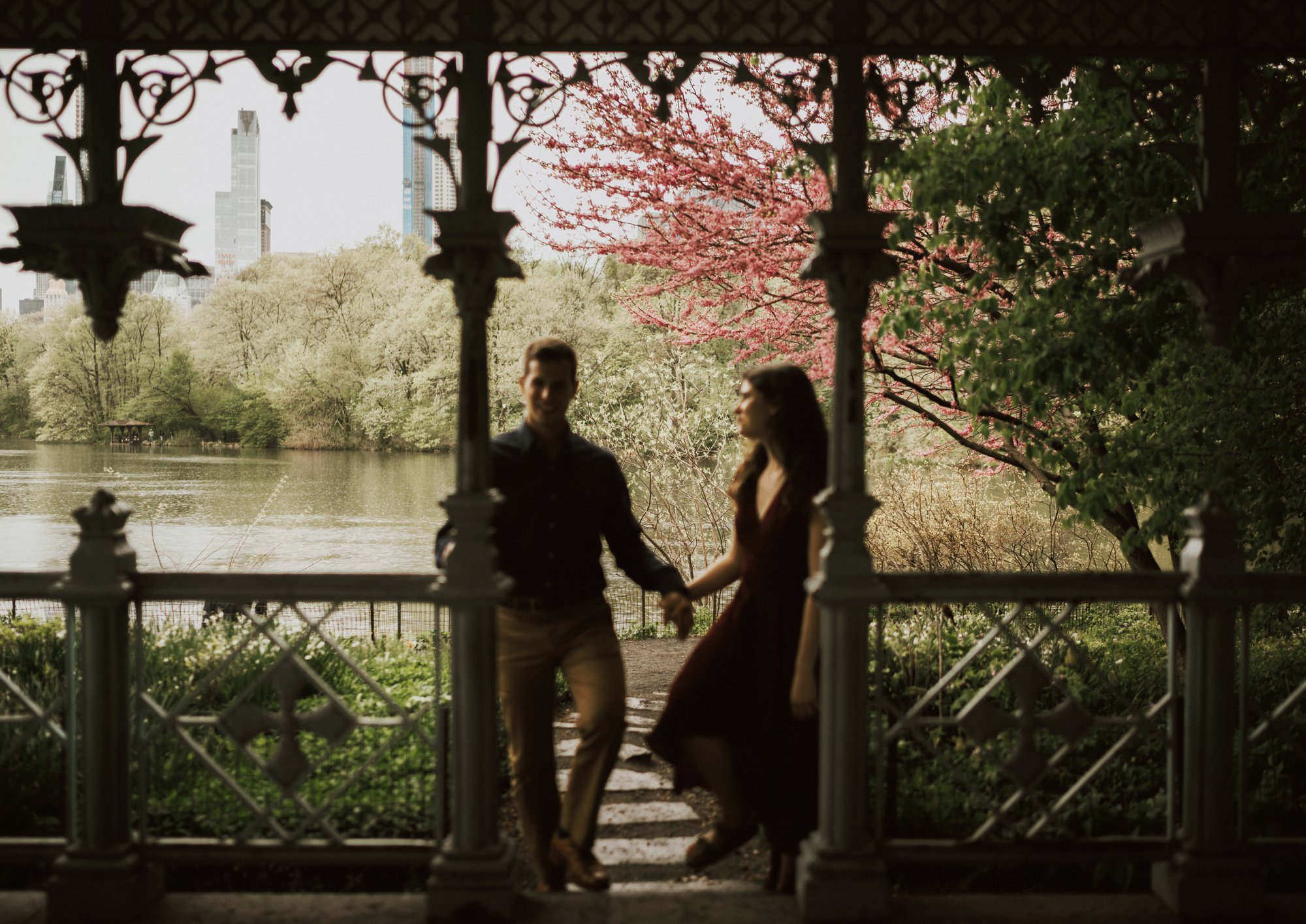  couple taking their engagement photos at ladies pavilion in central park by the Central Park lake 