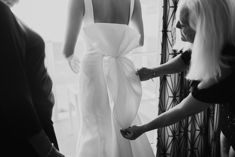 bride putting on wedding dress at the confidante hotel in Miami 