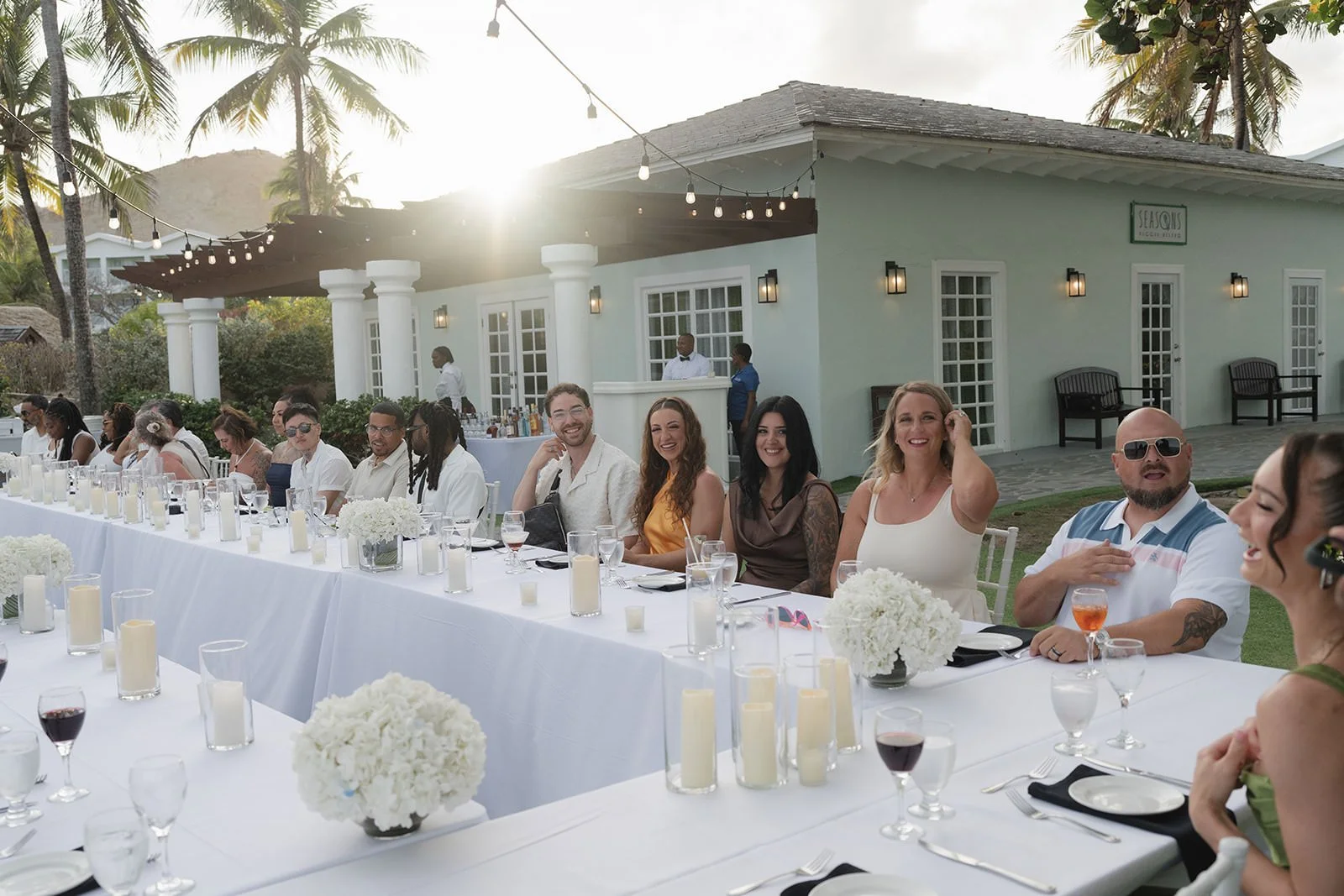 Wedding guests gathered outside a white beachfront building at Coconut Bay Beach Resort, St. Lucia
