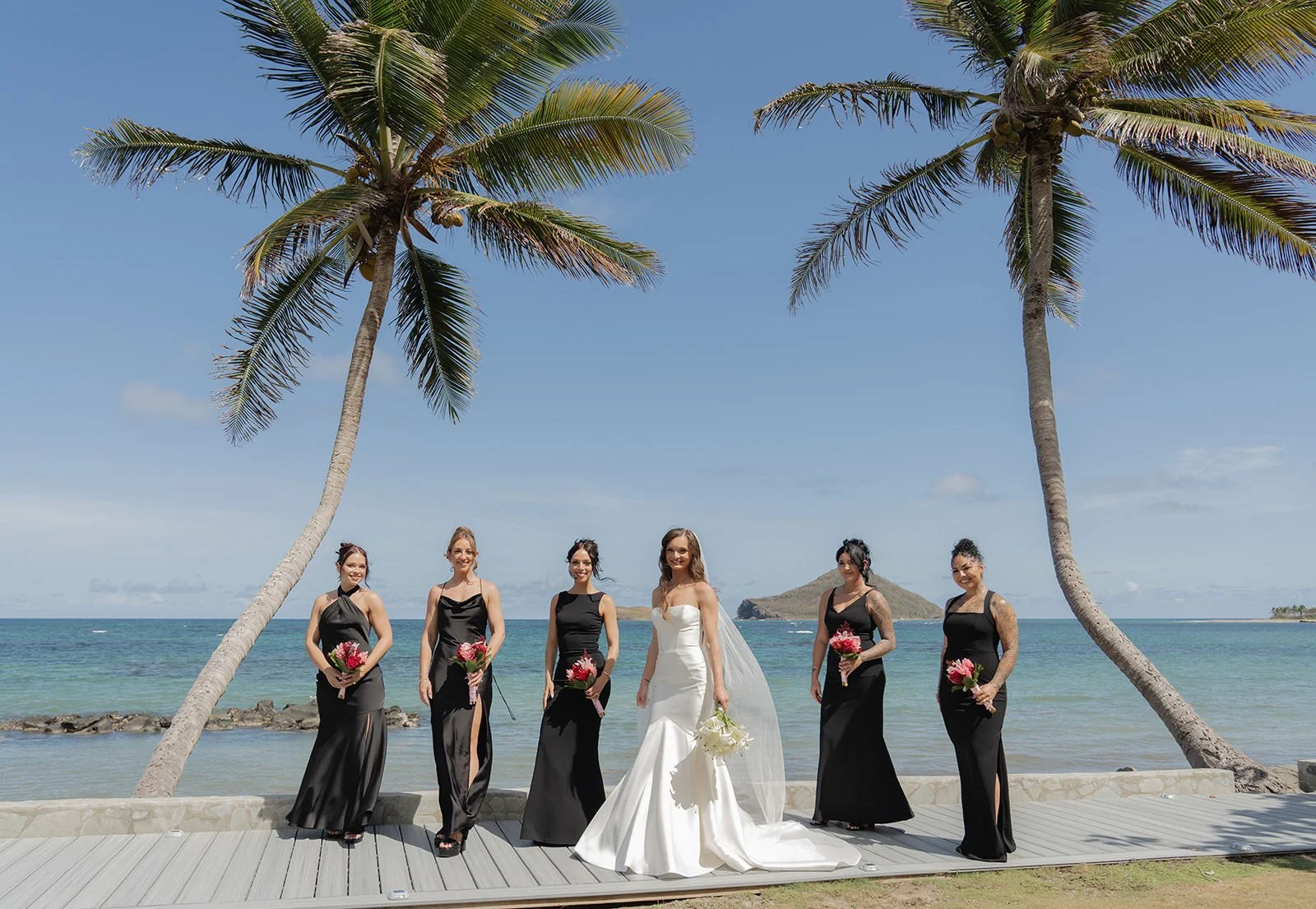 Wedding party posing together on the St. Lucia beach after the ceremony