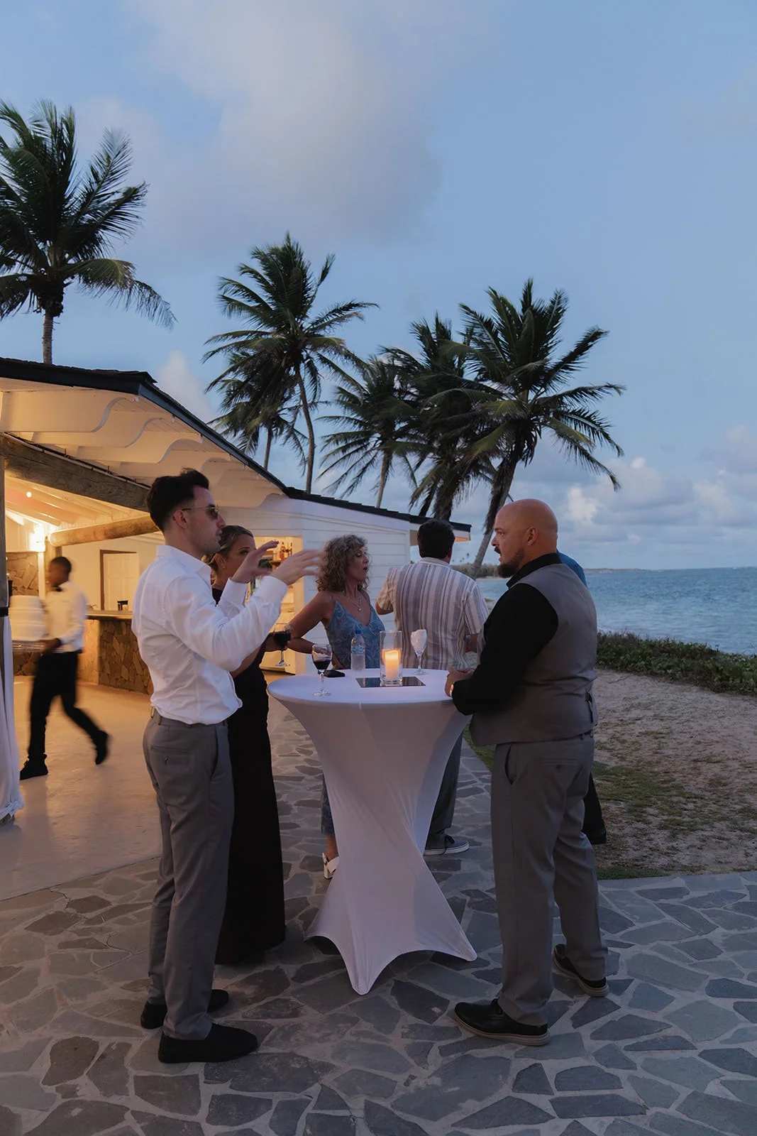 Bride and groom posing with wedding guests on the St. Lucia beach after the ceremony