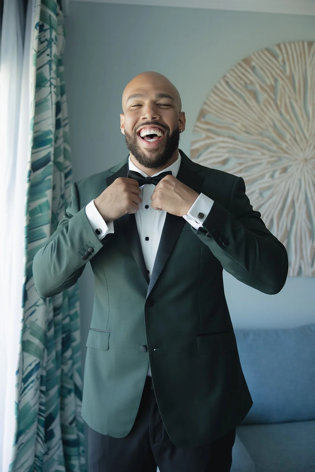 Guest in a teal jacket singing into a microphone at the St. Lucia wedding reception