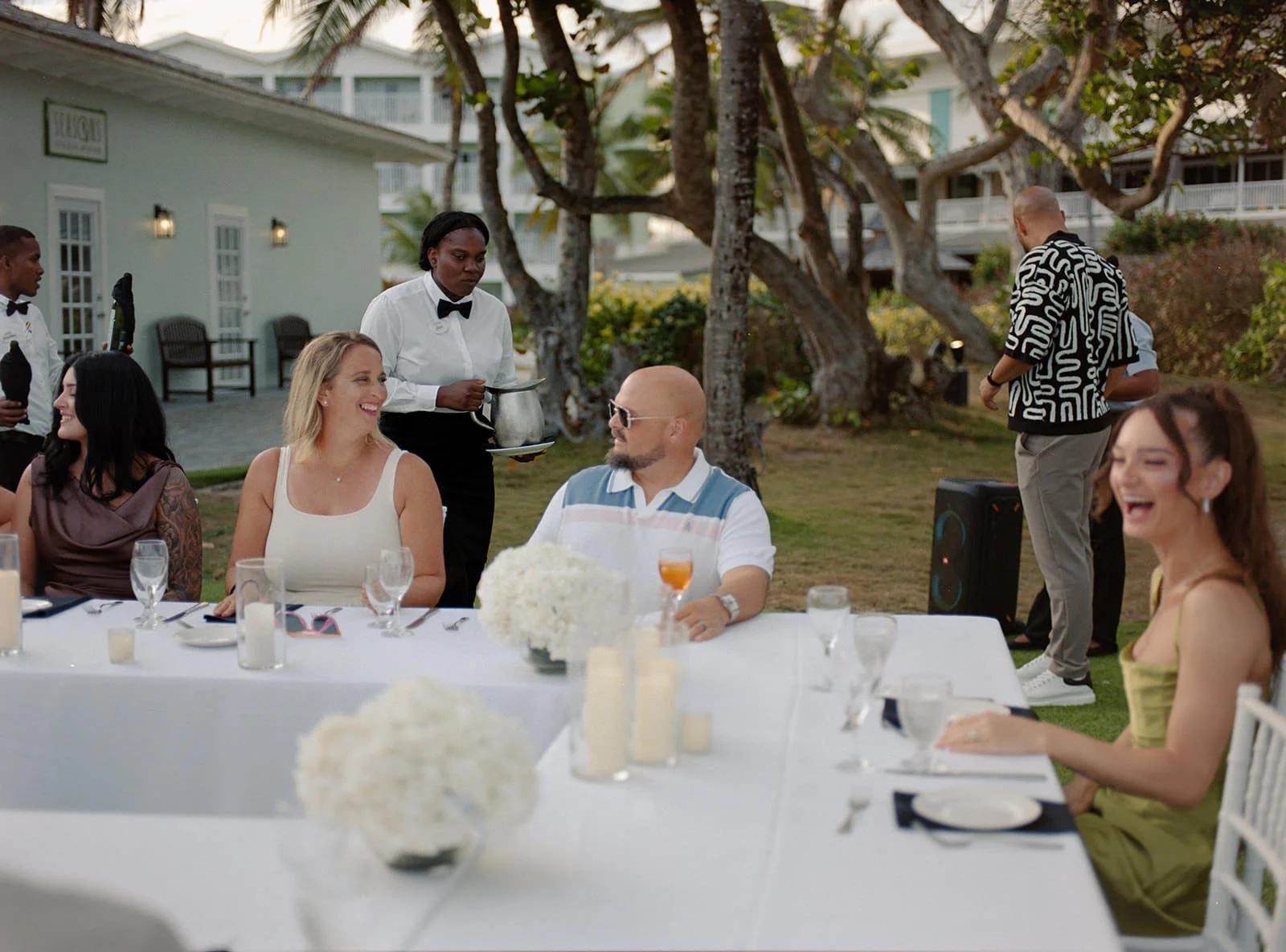 Guests raising a toast at the welcome dinner table, St. Lucia destination wedding
