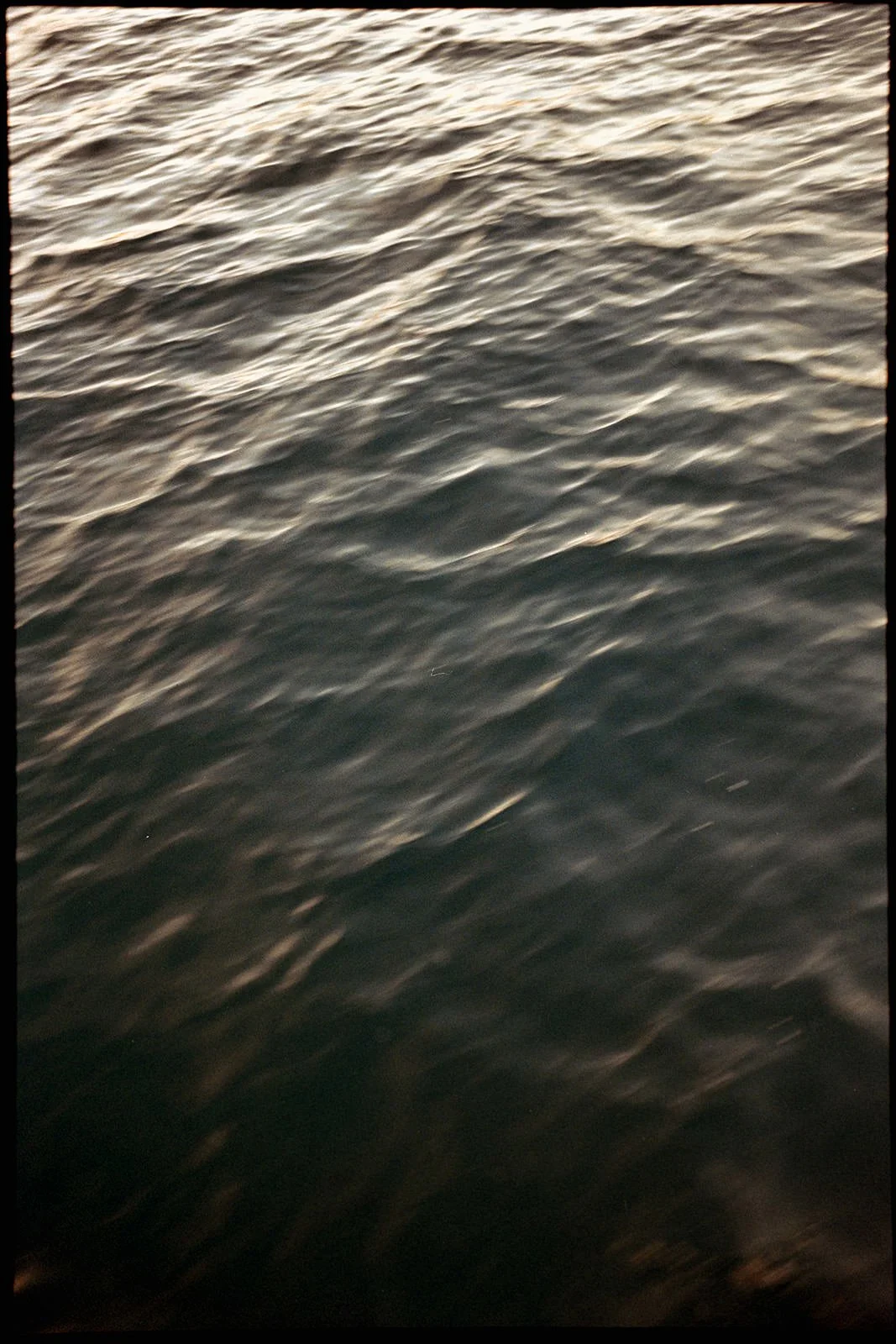 Close-up of dark rippling water beside the catamaran during the wedding weekend sailing excursion in St. Lucia