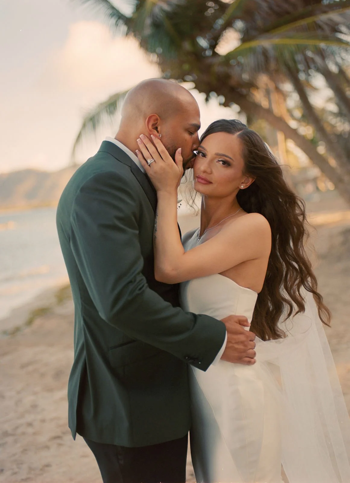 Groom tenderly kissing the bride's forehead in a close-up portrait at the St. Lucia wedding