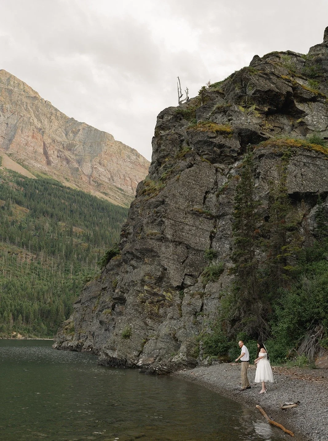 skipping rocks in glacier national park, this wedding weekend was one for the books. #glaciernationalparkwedding #miamiweddingphotographer #montanawedding