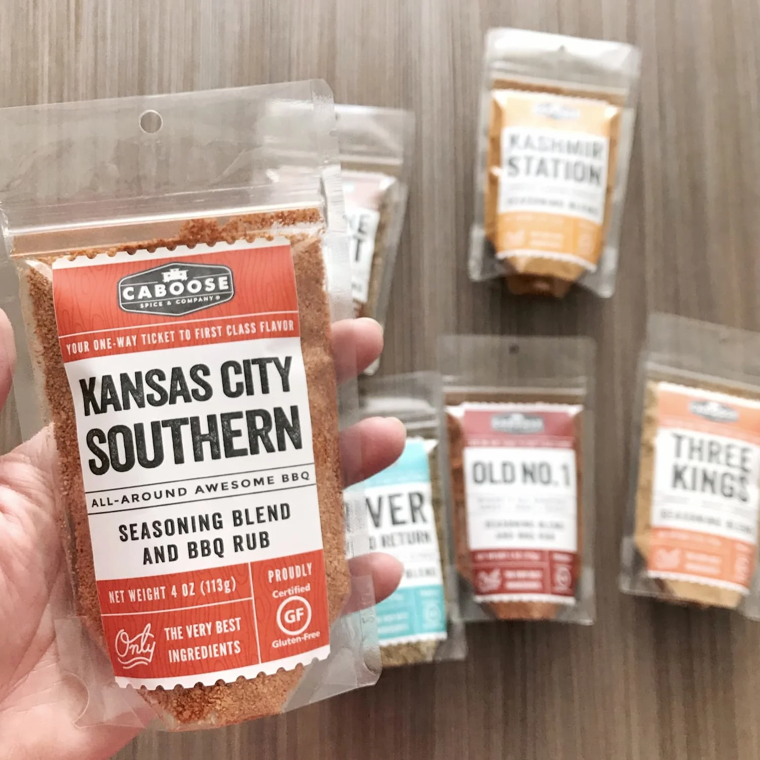Kansas City Southern Rub 4 oz pouch in hand size reference.jpg