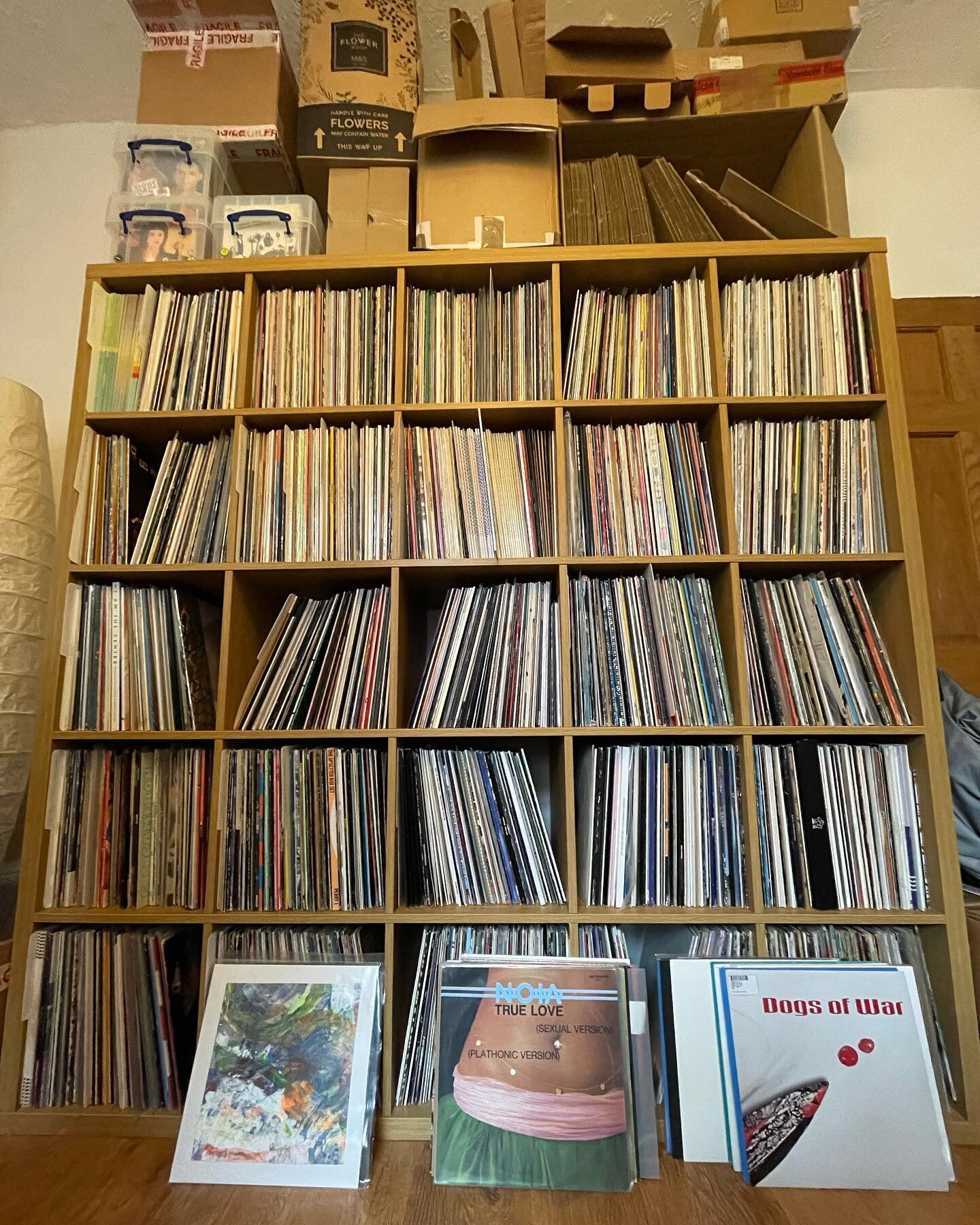 Tip. Stack cardboard boxes on top of record shelves to make it look more impressive.