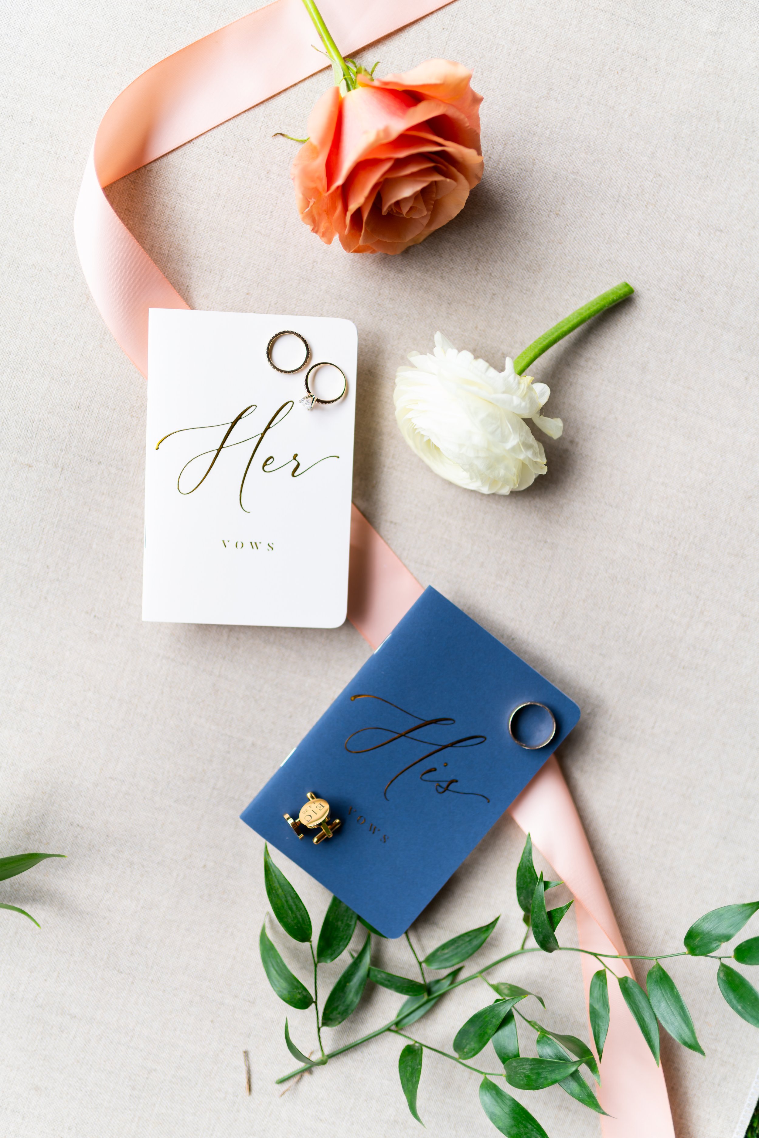 Wedding vow books and rings flat lay
