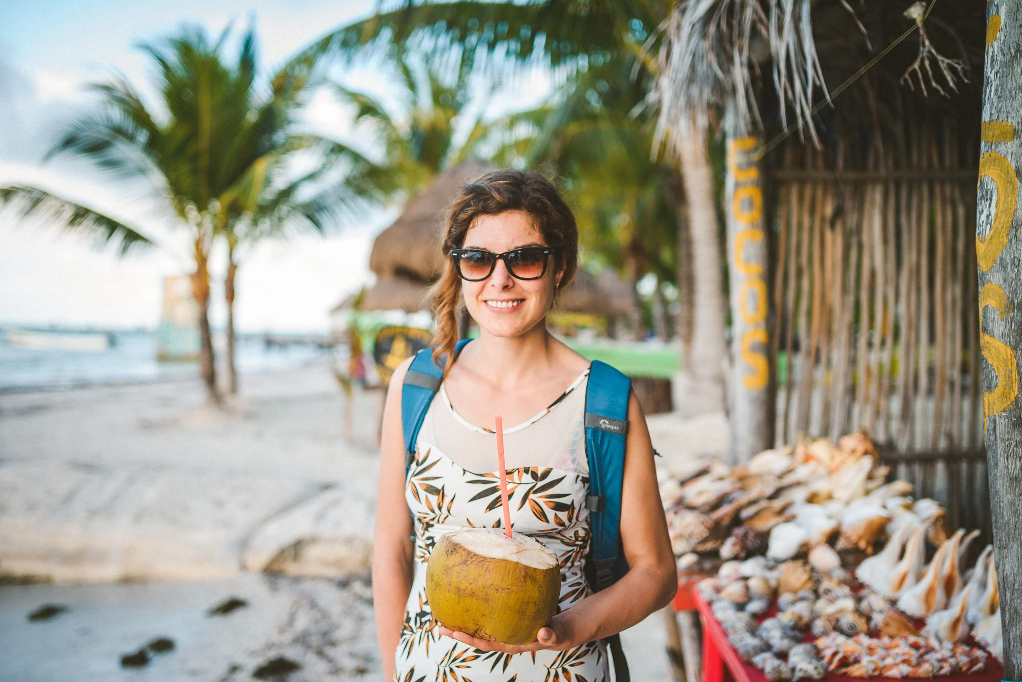 mujer tomando un coco en holbox
