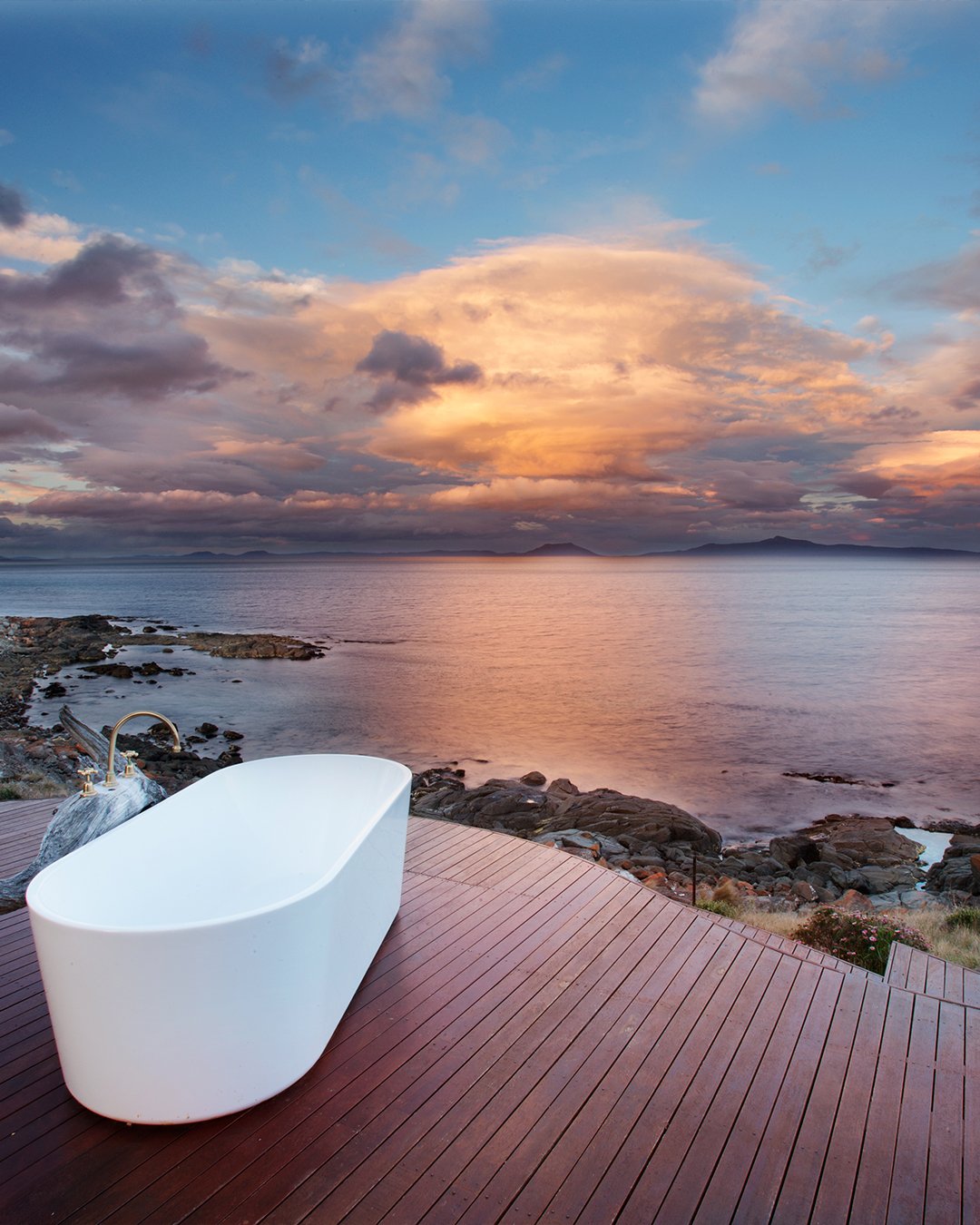 Inside Thalia Haven Tasmania looking out toward the Great Oyster Bay coastal landscape — the environment remaining present within the ritual space