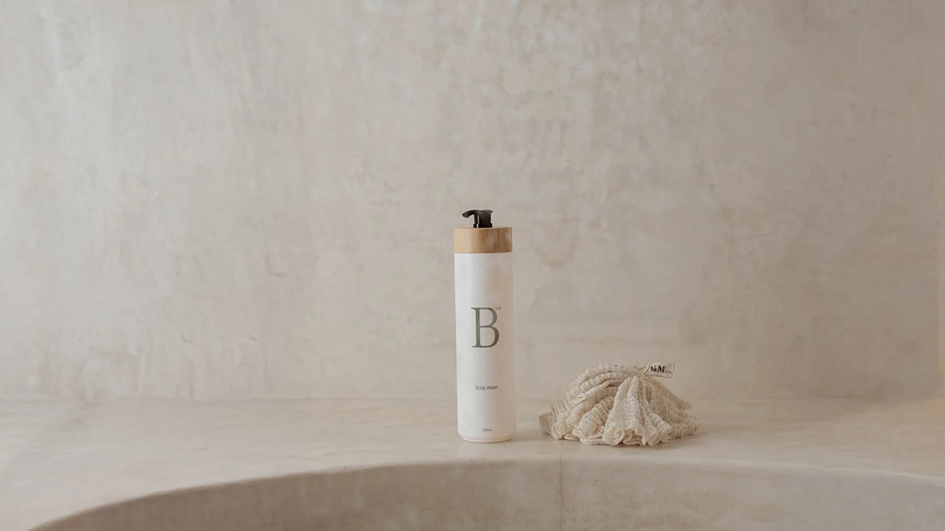 V&M SPA body ritual — natural body care for sensitive skin in a minimal stone bathroom with soft winter morning light