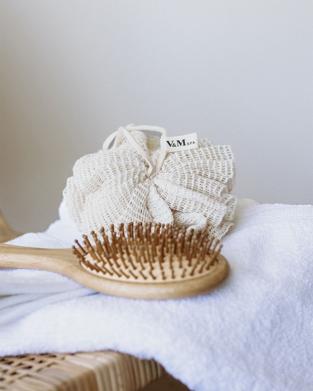 Hydrating shampoo and treatment conditioner presented on a stone tray with natural textures