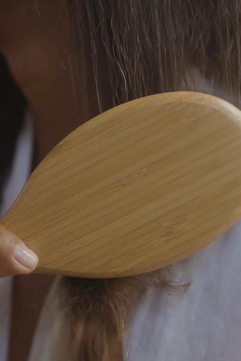 Brushing dry hair gently to preserve hair fibre strength and reduce unnecessary stress