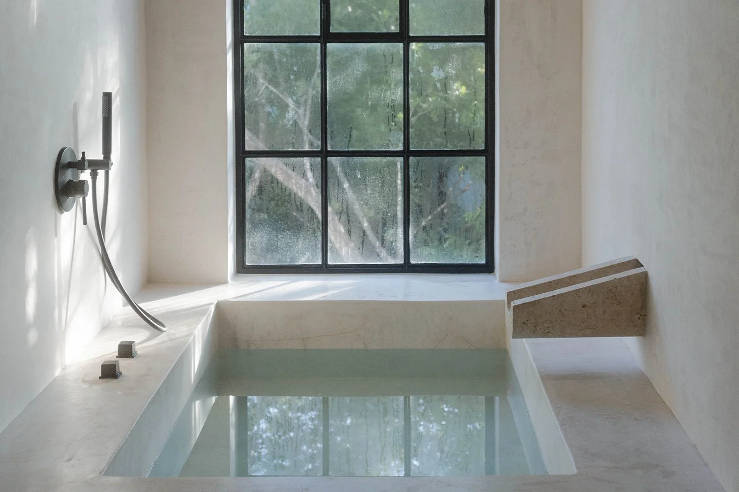 Still bath water in a minimalist setting, symbolising sustainable and considered care rituals
