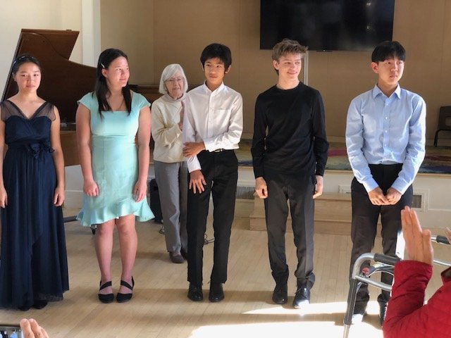   Nov ‘23 - BMC President, Edna Steele, with this month’s student performers: Melissa Lam (age 15, cello), Nadia Karpenko (age 16, violin), Leo Denizen (age 13, piano), Ariel Pawlik-Zwiebel (age 16, violin), Casey Kim (age 15, cello).  