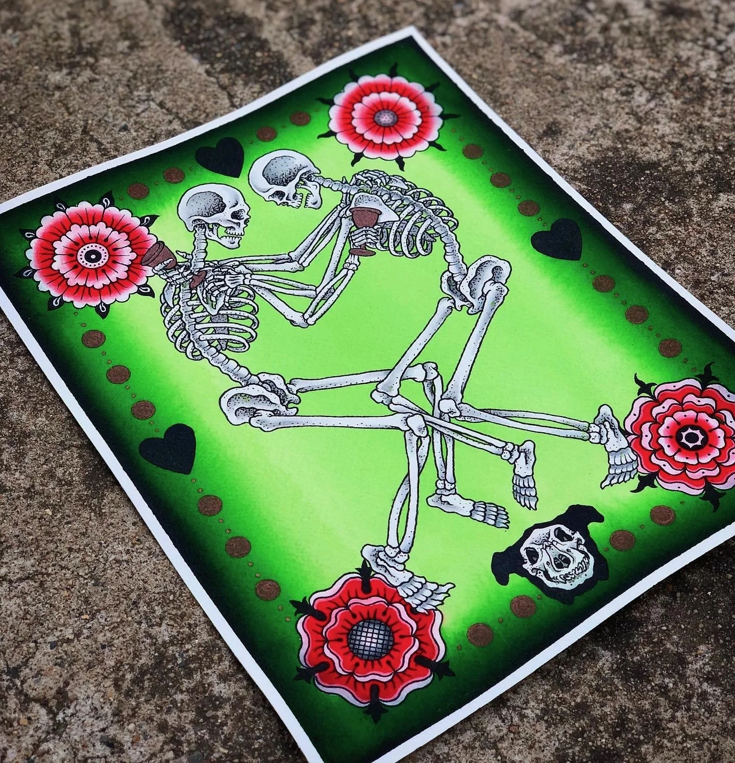 Colorful art piece with two skeletons dancing, surrounded by pink and red flowers, black hearts, and brown dots on a green background.