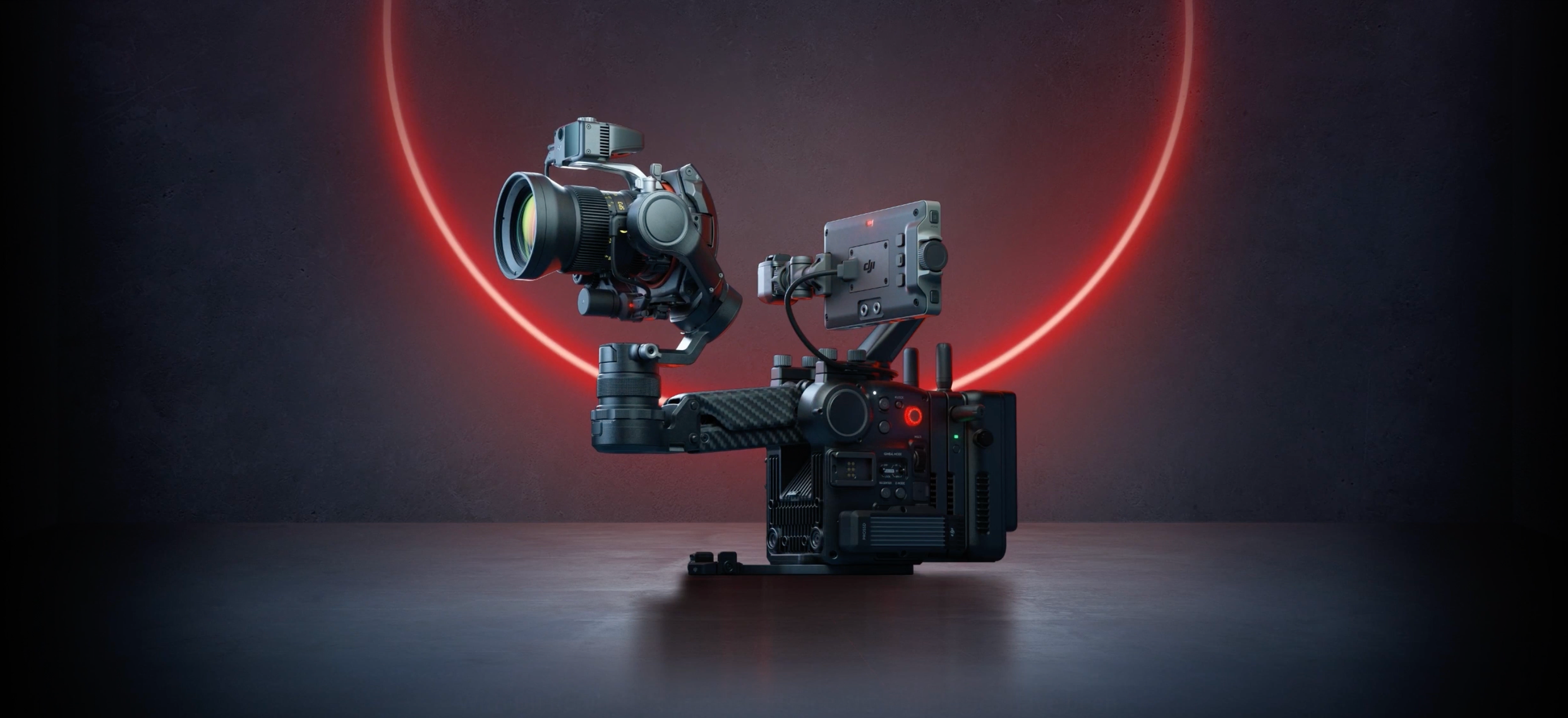 A professional cinematic camera setup with a mounted lens, monitor, and stabilizer on a dark surface, with a glowing red neon heart shape in the background.