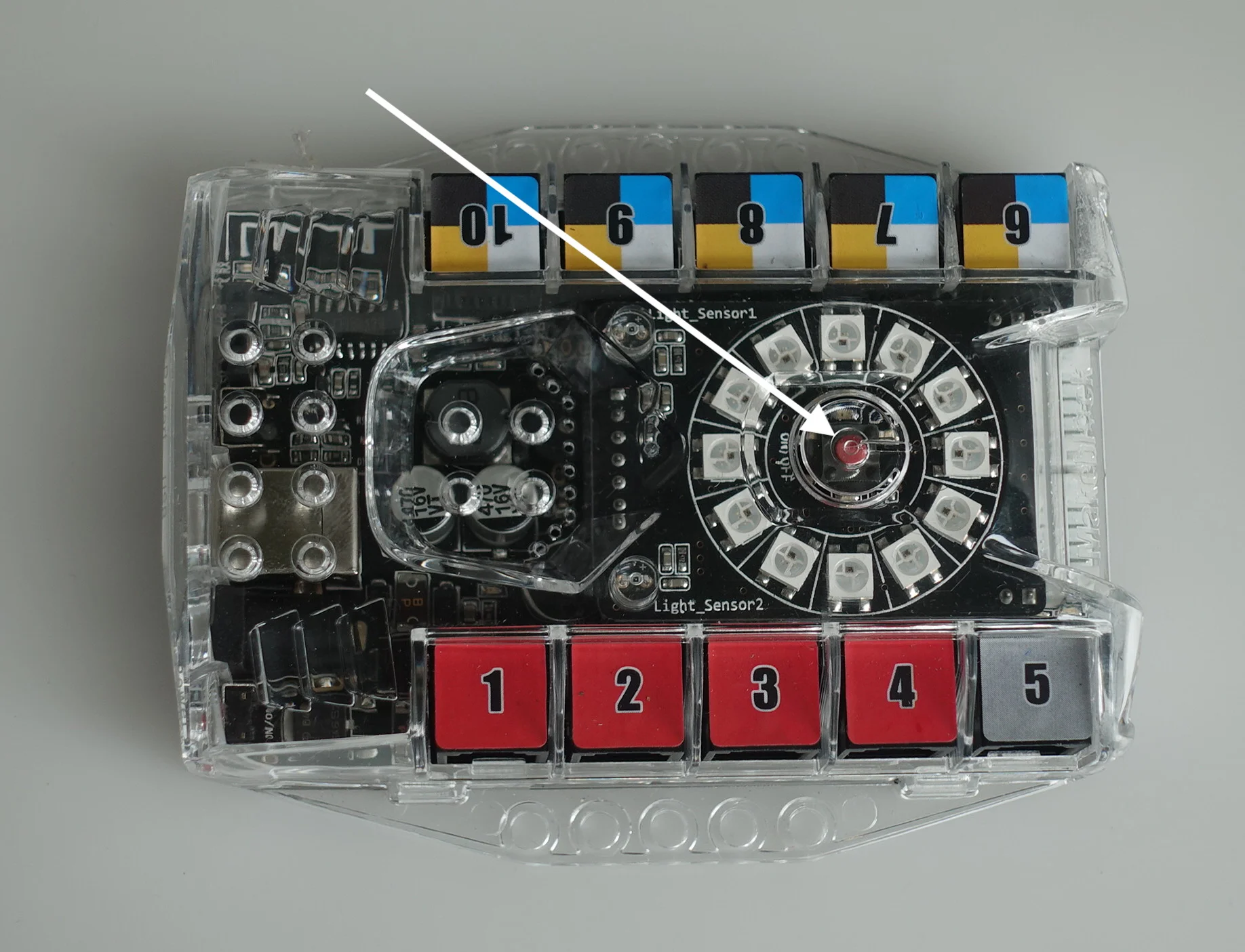 This is the Auriga. It should be attached to the robot via Velcro to the robot and connected by two cables (in ports 1 and 5). The white arrow in this picture points to the power button.