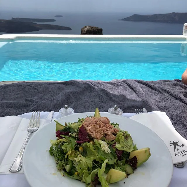 Talk about a healthy lunch with a view! We&rsquo;ve left #Iceland for the second part of our #honeymoon and we are thawing-out in #santorini #greece !
This salad is lettuce, corn, tuna, quinoa, cucumbers and a delightfully fruity vinegarette dressing
