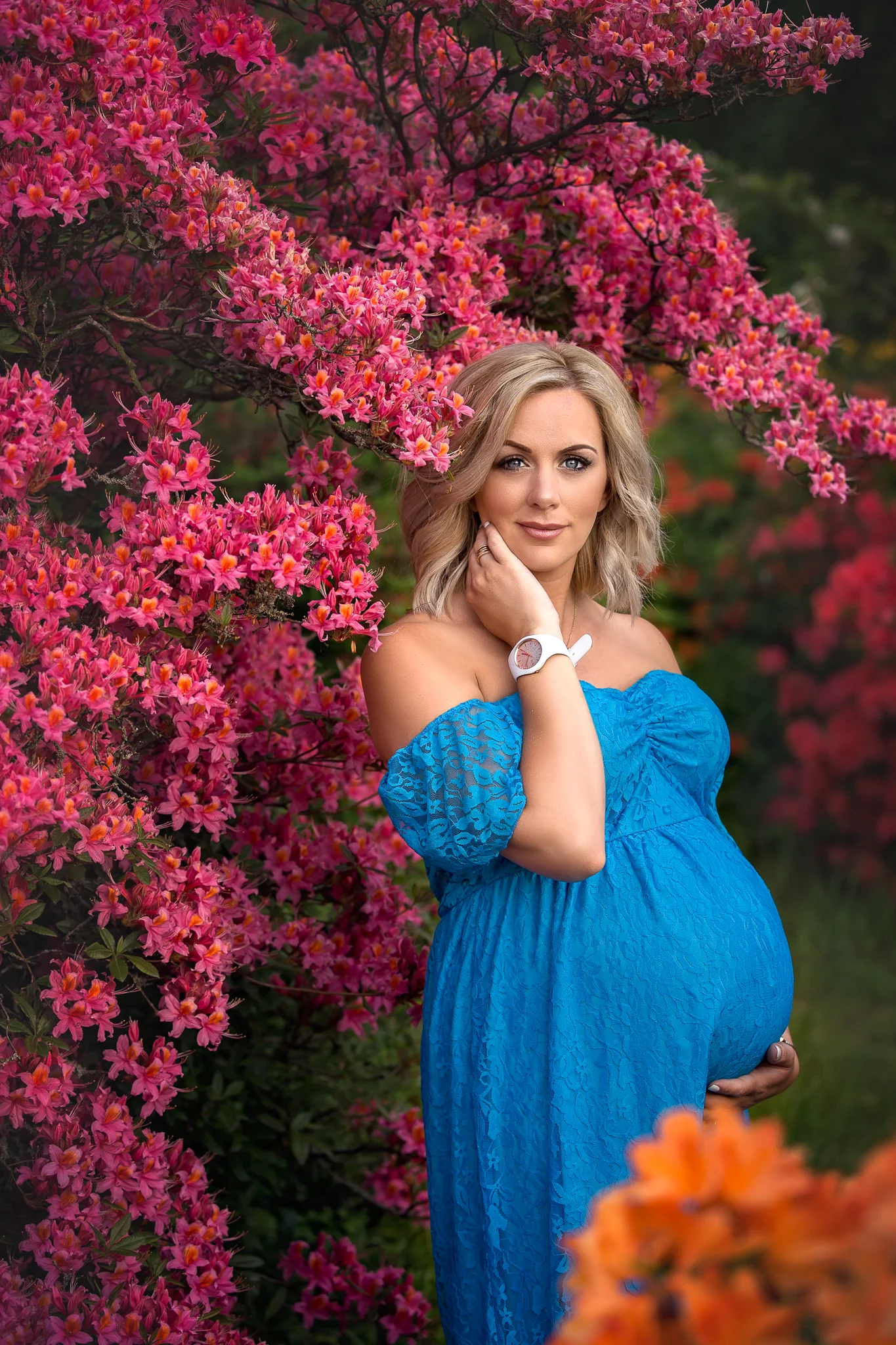 Maternity shoot Leeds: beautiful blond pregnant woman in a long blue dress standand 