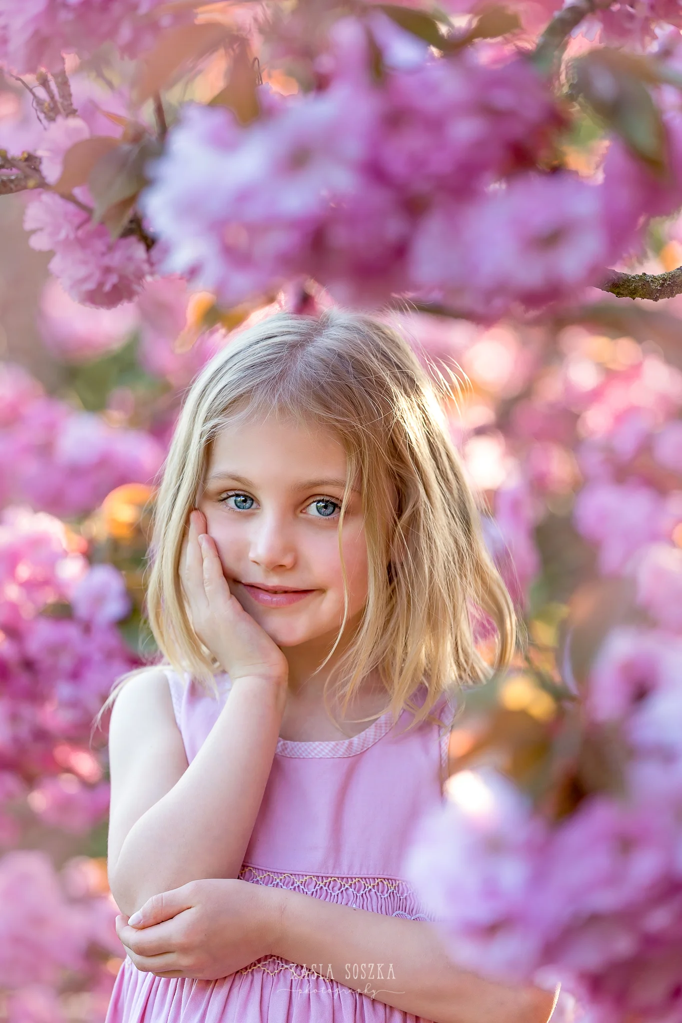 Leeds child photography Bradford child session York children photography: pretty little blond girl in a pink dress under blooming cherry tree