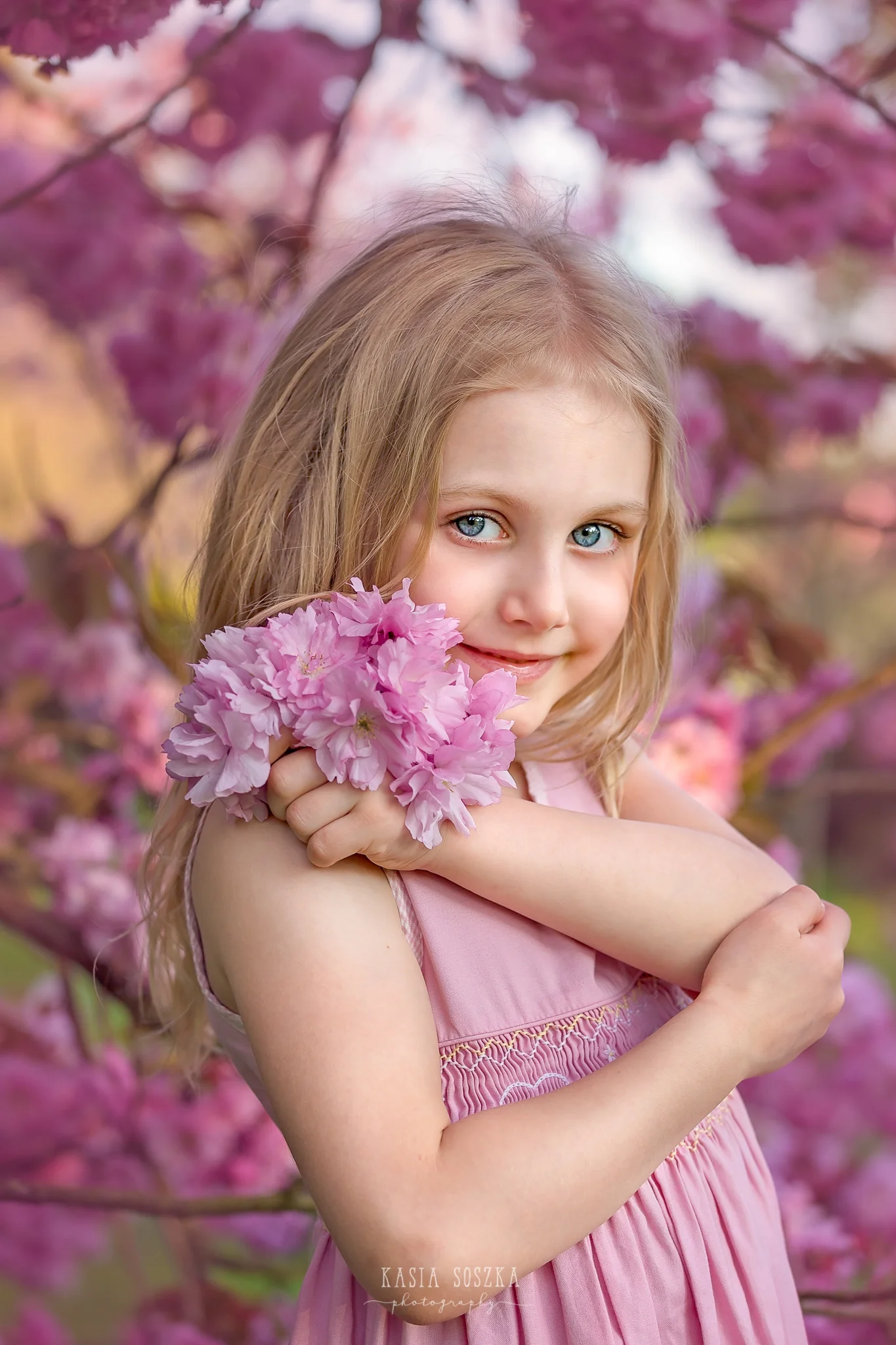Leeds child photography Bradford child session York children photography: pretty little blond girl in a pink dress under blooming cherry tree