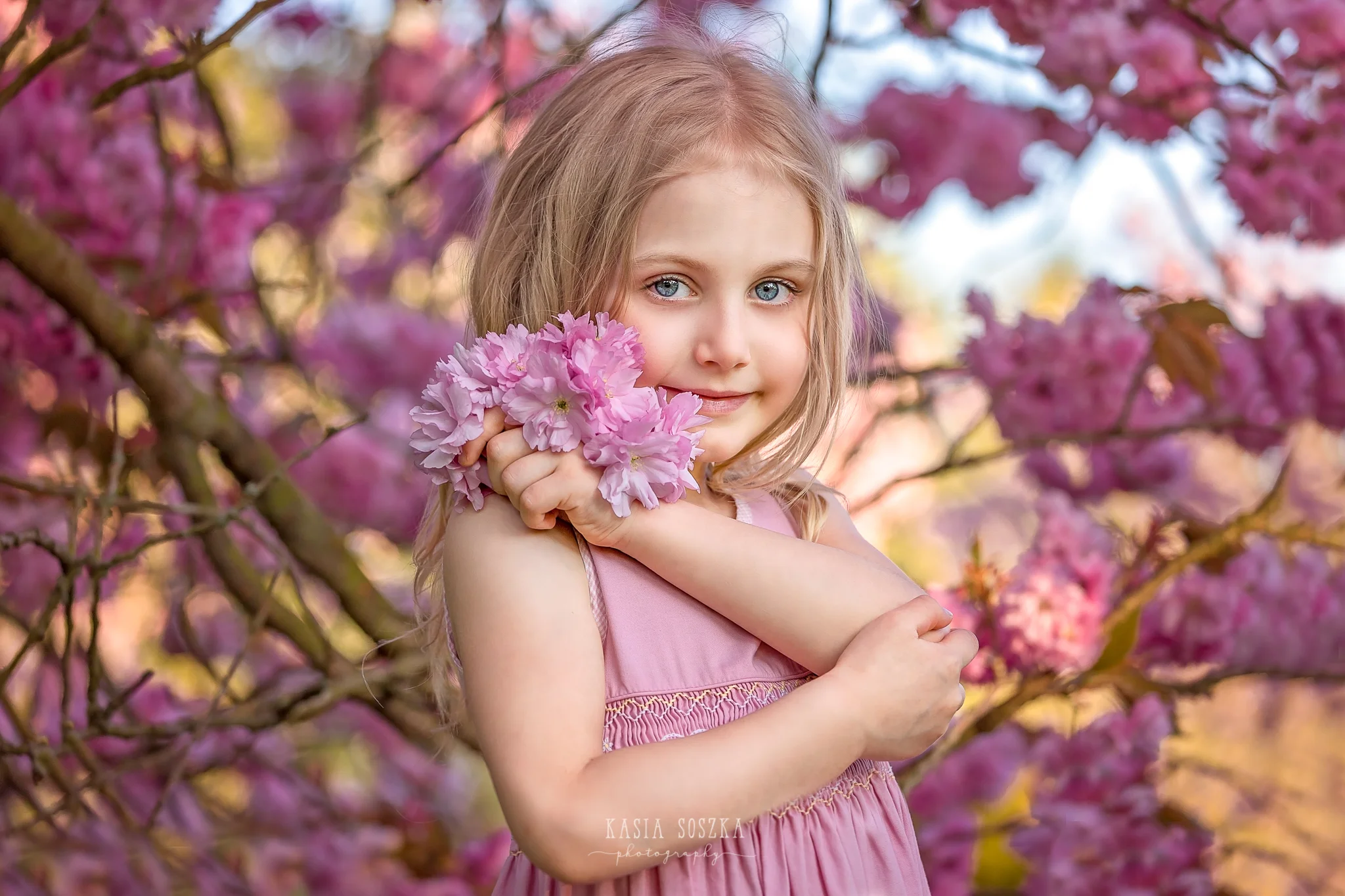 Leeds child photography Bradford child session York children photography: pretty little blond girl in a pink dress under blossoming cherry tree