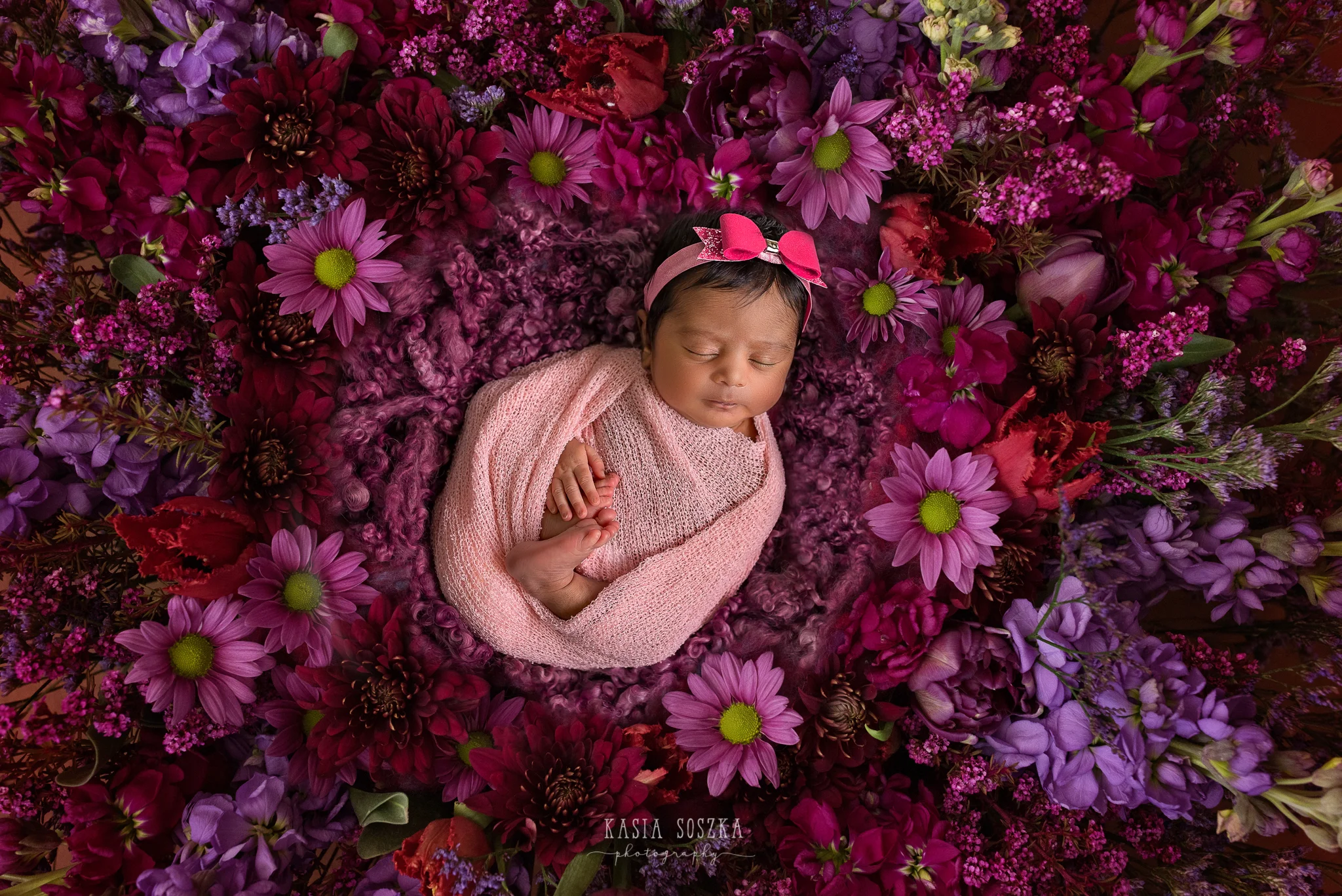 Newborn photography Leeds-Bradford-York-Harrogate: newborn baby girl sleeping on a bed of flowers