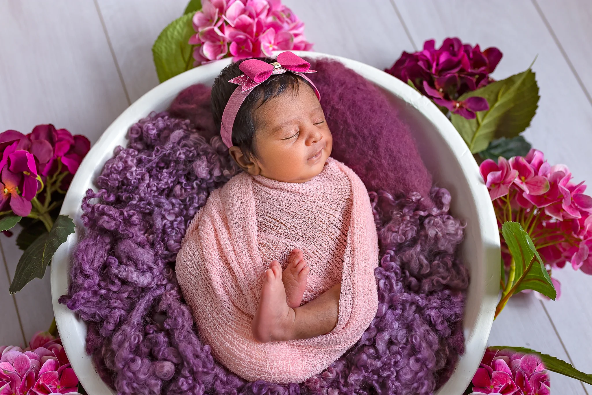 Newborn photography Leeds-Bradford-York-Harrogate: newborn baby girl wrapped in a pink blanket