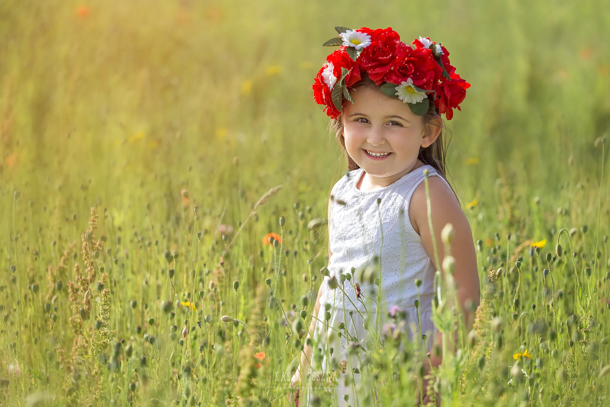 Children photography Leeds, child outdoor summer session Yorkshire: cute little girl walking through summer meadow