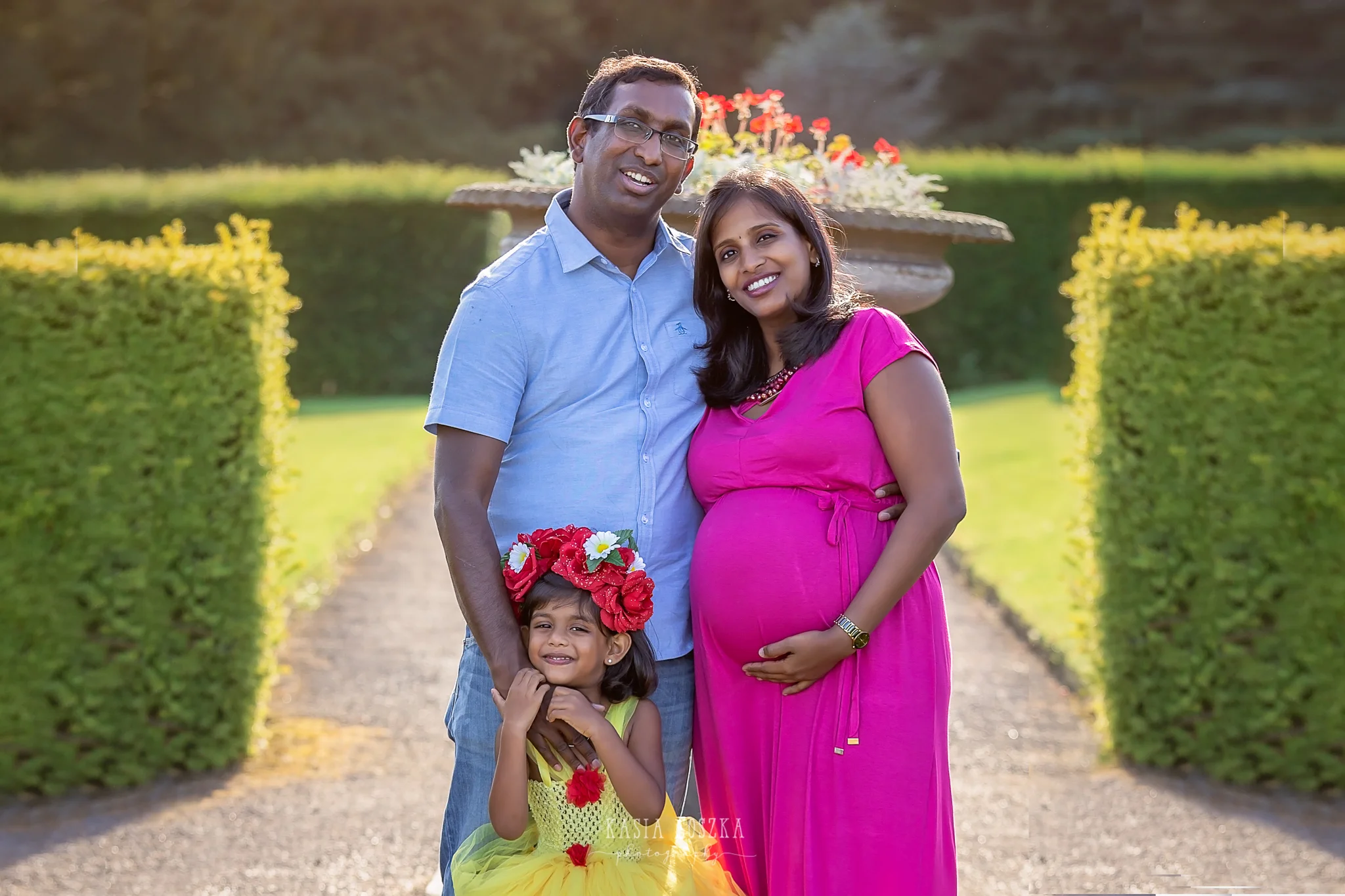 Family photography Leeds, maternity photography Leeds: beautiful young family waiting for a new family member posing for a family photo in a beautiful garden