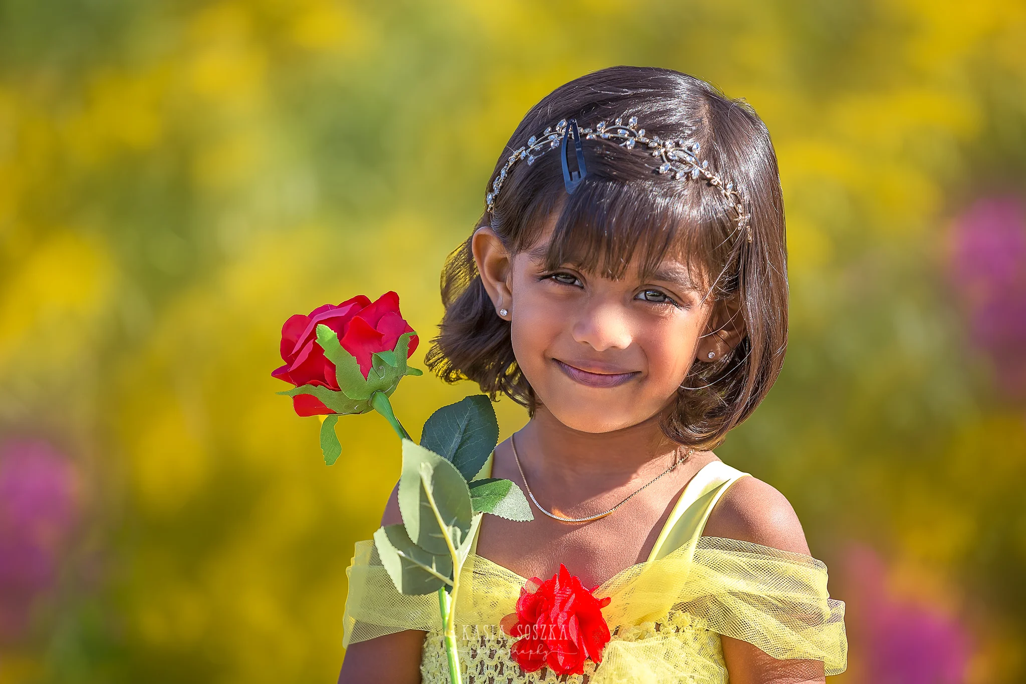 Child photography Leeds, child outdoor princess session Leeds, Yorkshire: beautiful little girl in a yellow princess dress holding a red rose