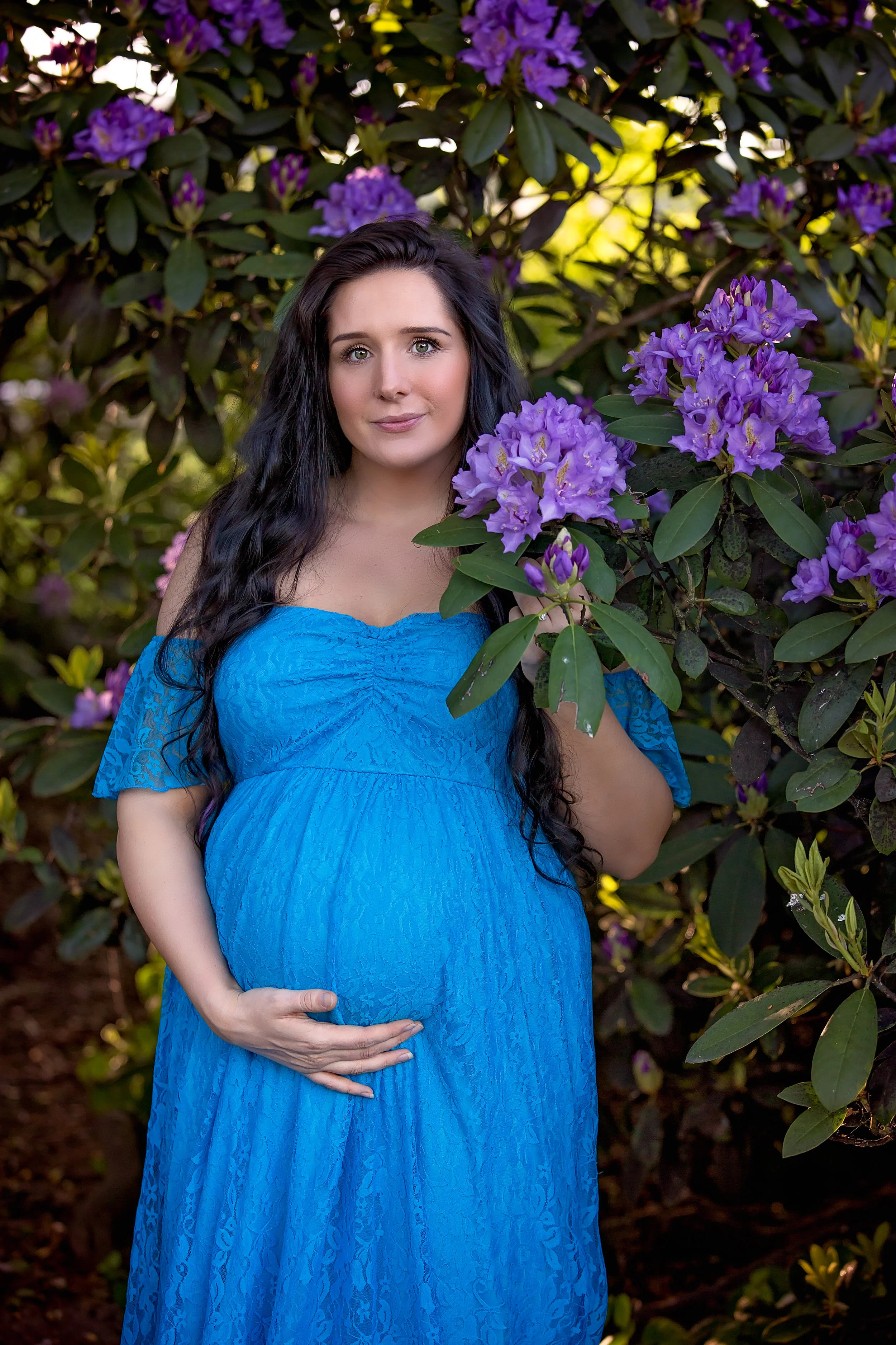 Maternity photography Leeds, Yorkshire, pregnancy session Leeds: beautiful pregnant woman with long black holding a branch of purple flowers