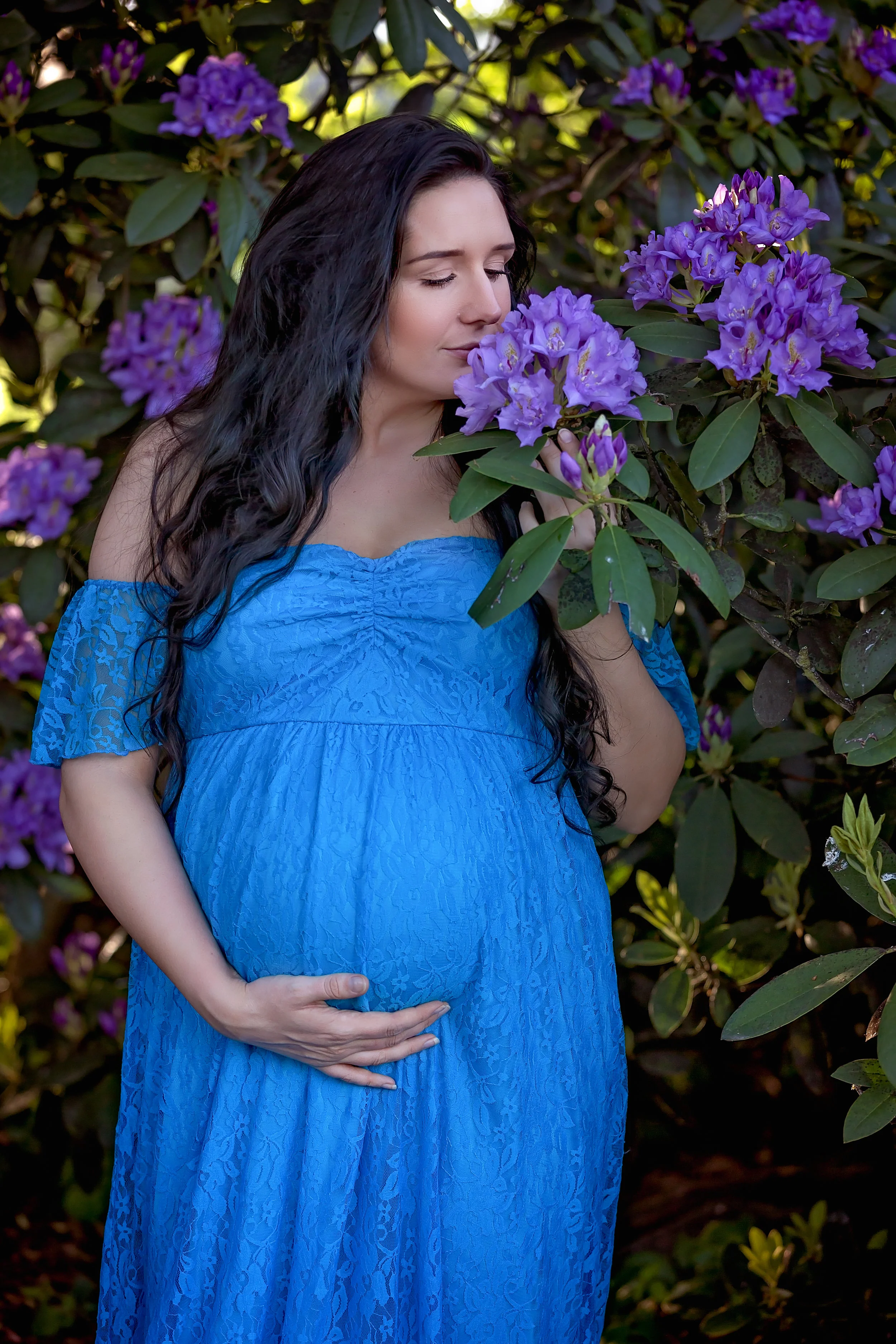 Maternity photography Leeds, Yorkshire, pregnancy session Leeds: beautiful pregnant woman with long black hair smelling spring flowers