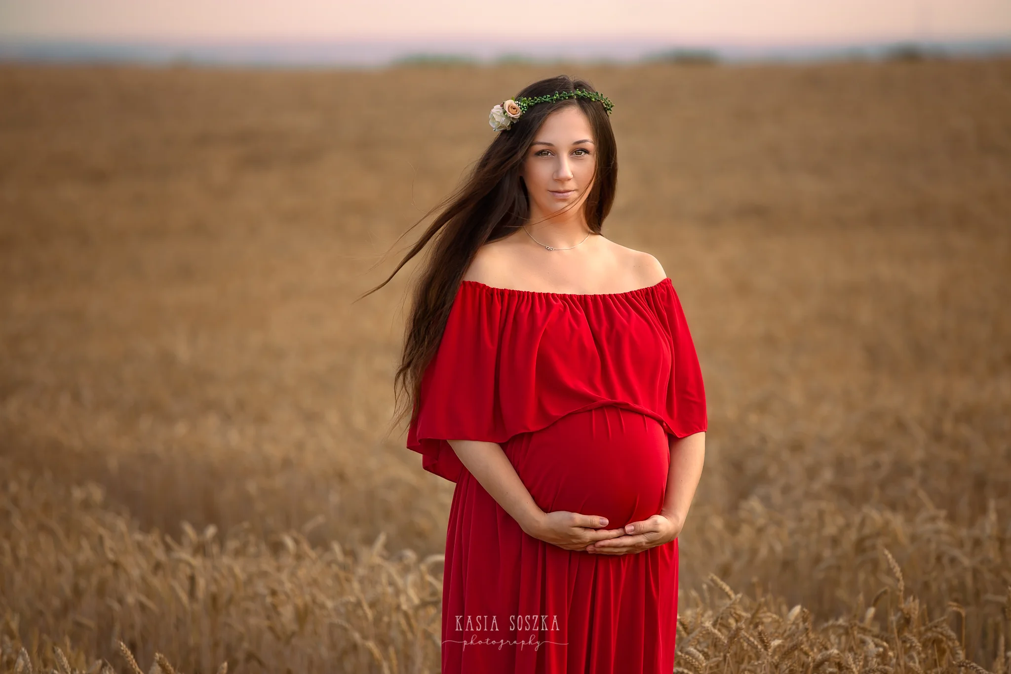 Maternity photography Yorkshire Leeds, Bradford, York, Harrogate, Wakefield: beautiful pregnant woman in red dress standing in the wheat field