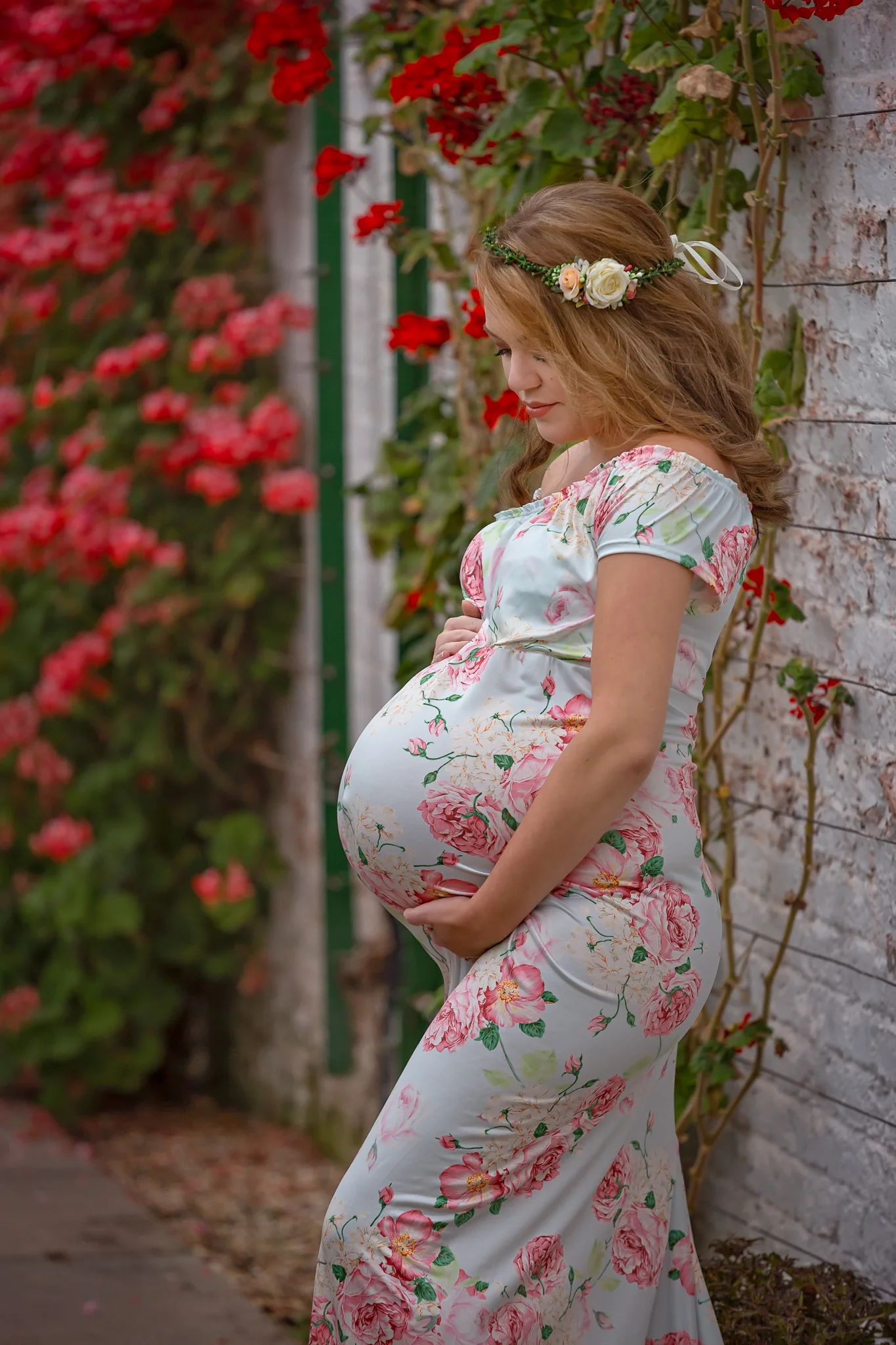 Maternity photography Leeds, Bradford, York, Harrogate: beautiful pregnant woman in a floral dress in a conservatory