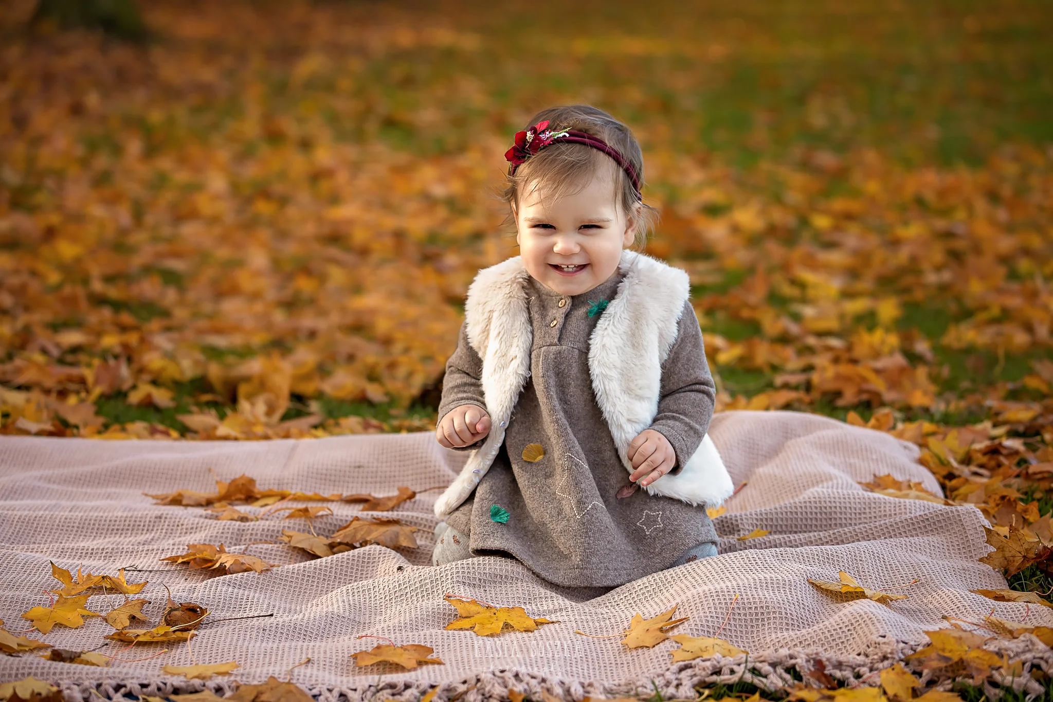 Baby milestone photography Leeds, York, Bradford, Harrogate: cute baby girl’s first birthday portrait session. Autumn outdoor baby photo shoot in a park in Leeds, Yorkshire