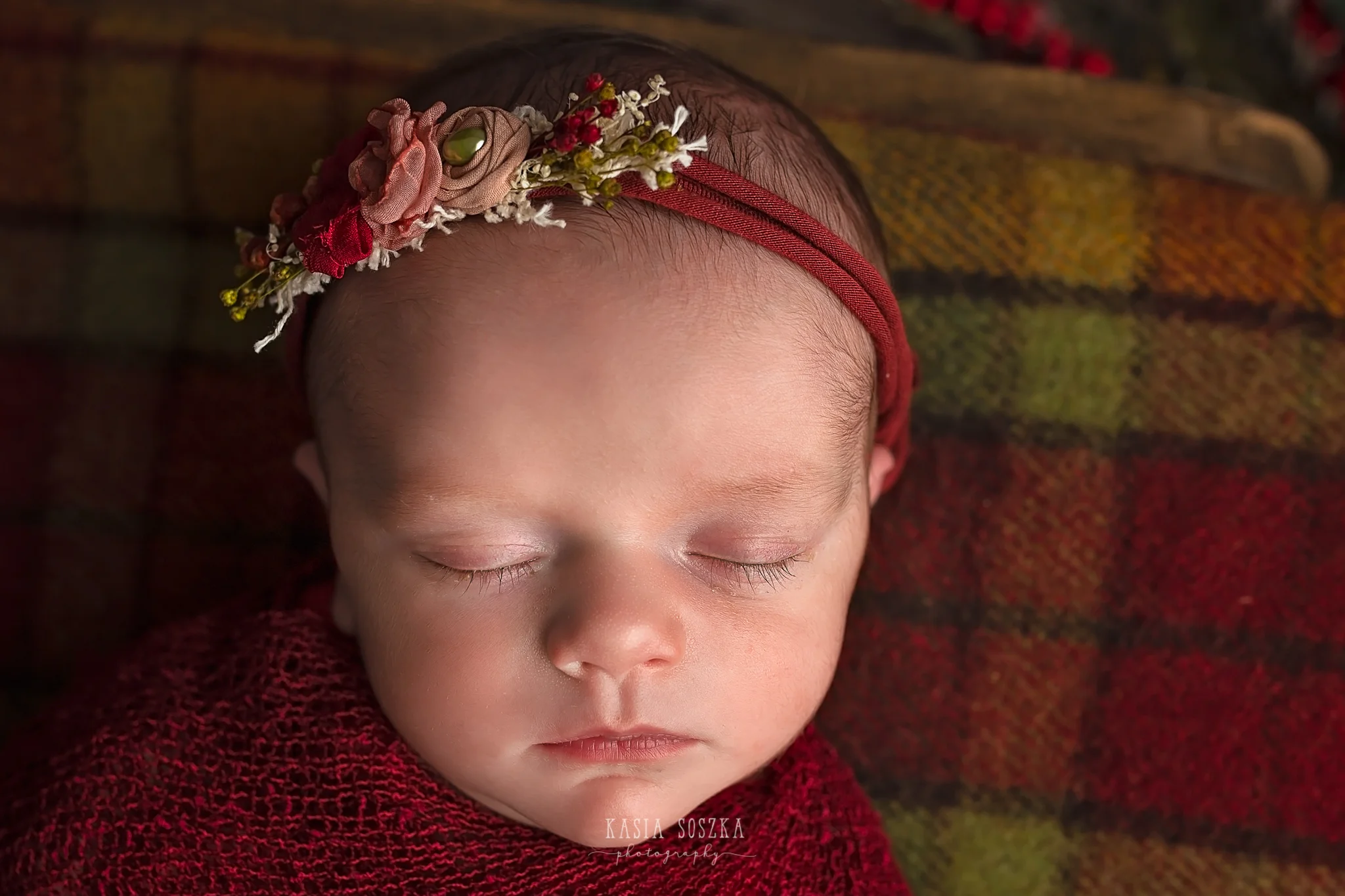 Newborn photography in Leeds near Bradford, York and Harrogate: close up of a cute newborn baby girl in Christmas set up
