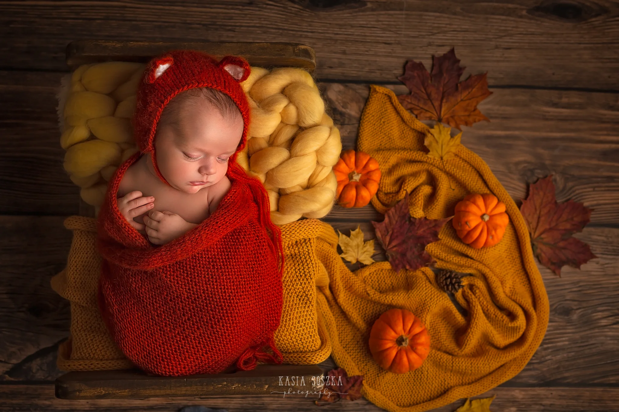 Newborn photography in Leeds near Bradford, York and Harrogate: cute newborn baby girl in fox outfit sleeping in a little bed