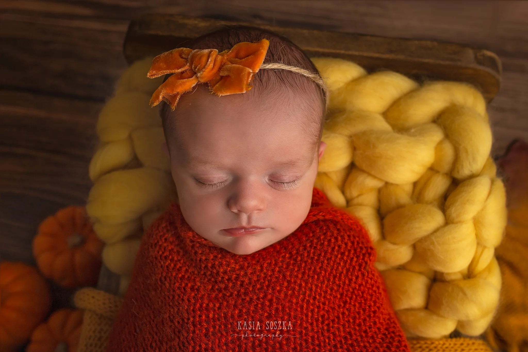 Newborn photography in Leeds near Bradford, York and Harrogate: cute newborn baby girl in autumn set up