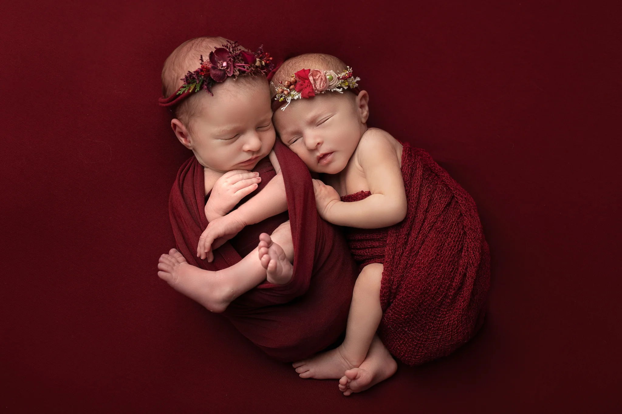 Newborn twin photographer Leeds, newborn photographer Leeds-York-Harrogate-Bradford, Yorkshire: winter theme twin session in Leeds, Yorkshire. Twin baby girls sleeping on a red blanket